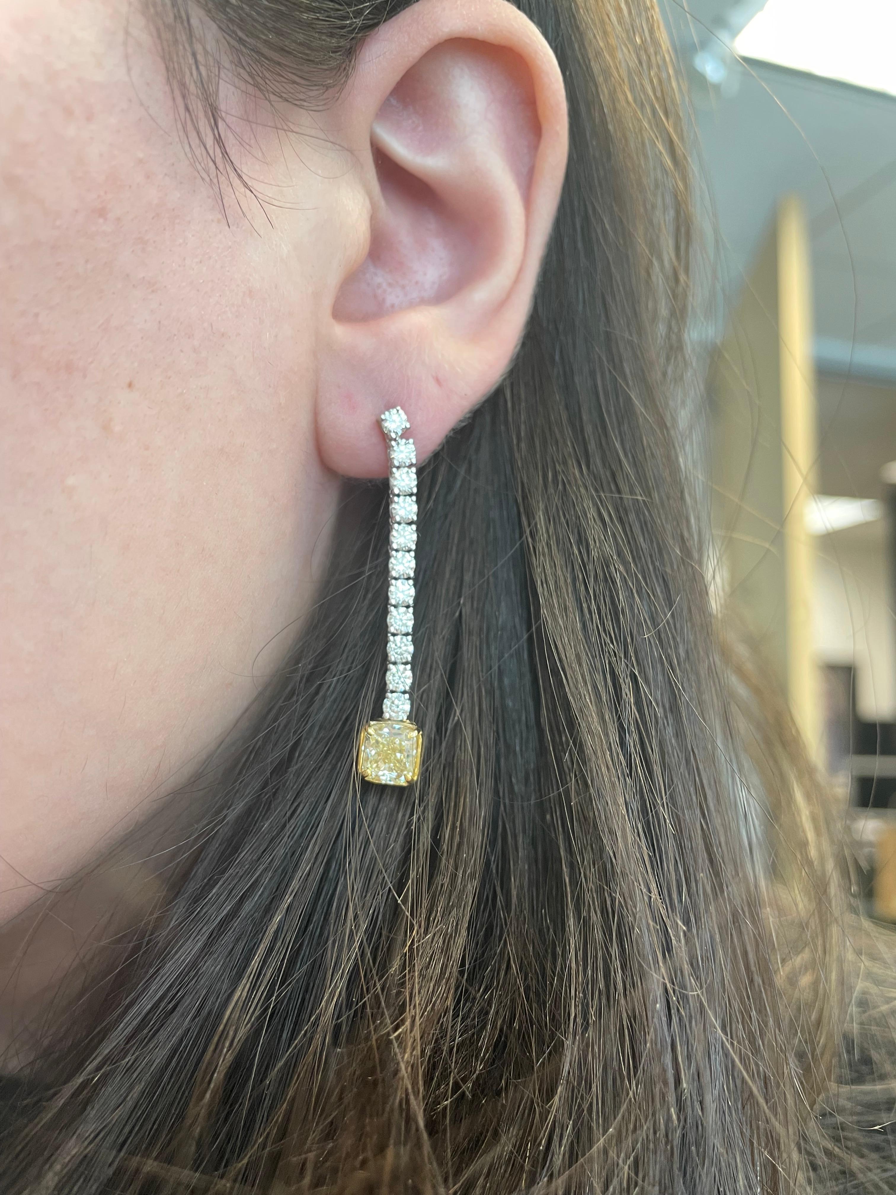 Stunning dangling diamond earring, each center stone GIA certified with “fancy yellow look”
Two matching center cushion diamonds 3.00 carats total. One stone YX color grade and ther other WX color grade. One stone VS1 clarity grade and the other SI1