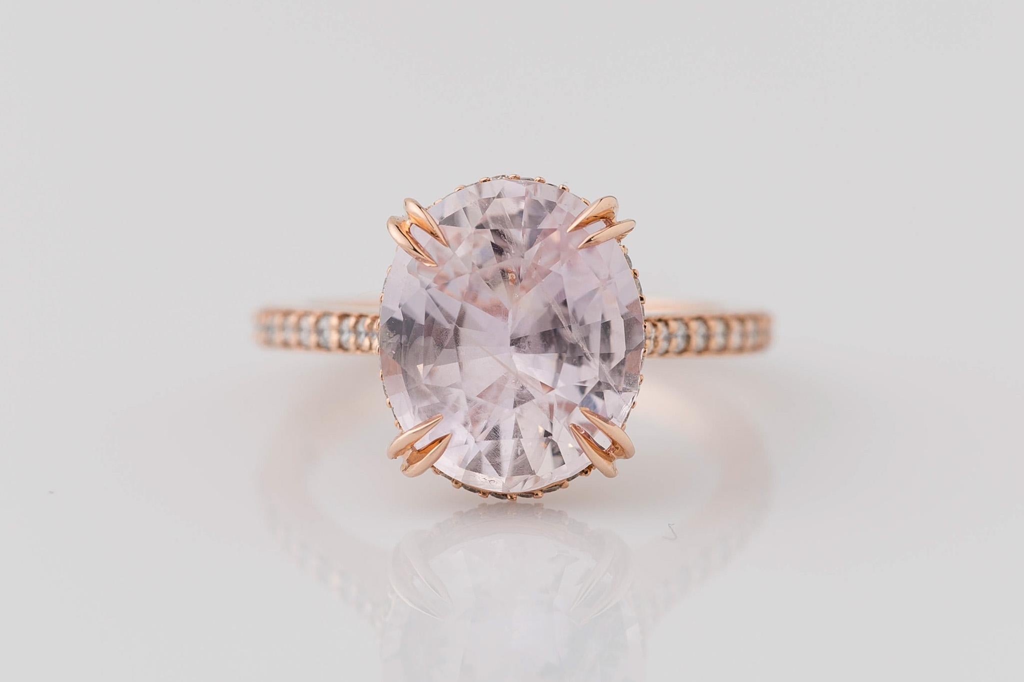 Prepare to say 'I do' with our enchanting GIA Certified 5.22 carat natural oval pink sapphire diamond engagement ring. The centerpiece boasts a delicate, light pale pink hue, radiating love and romance. Adorned with 18 dazzling round brilliant cut