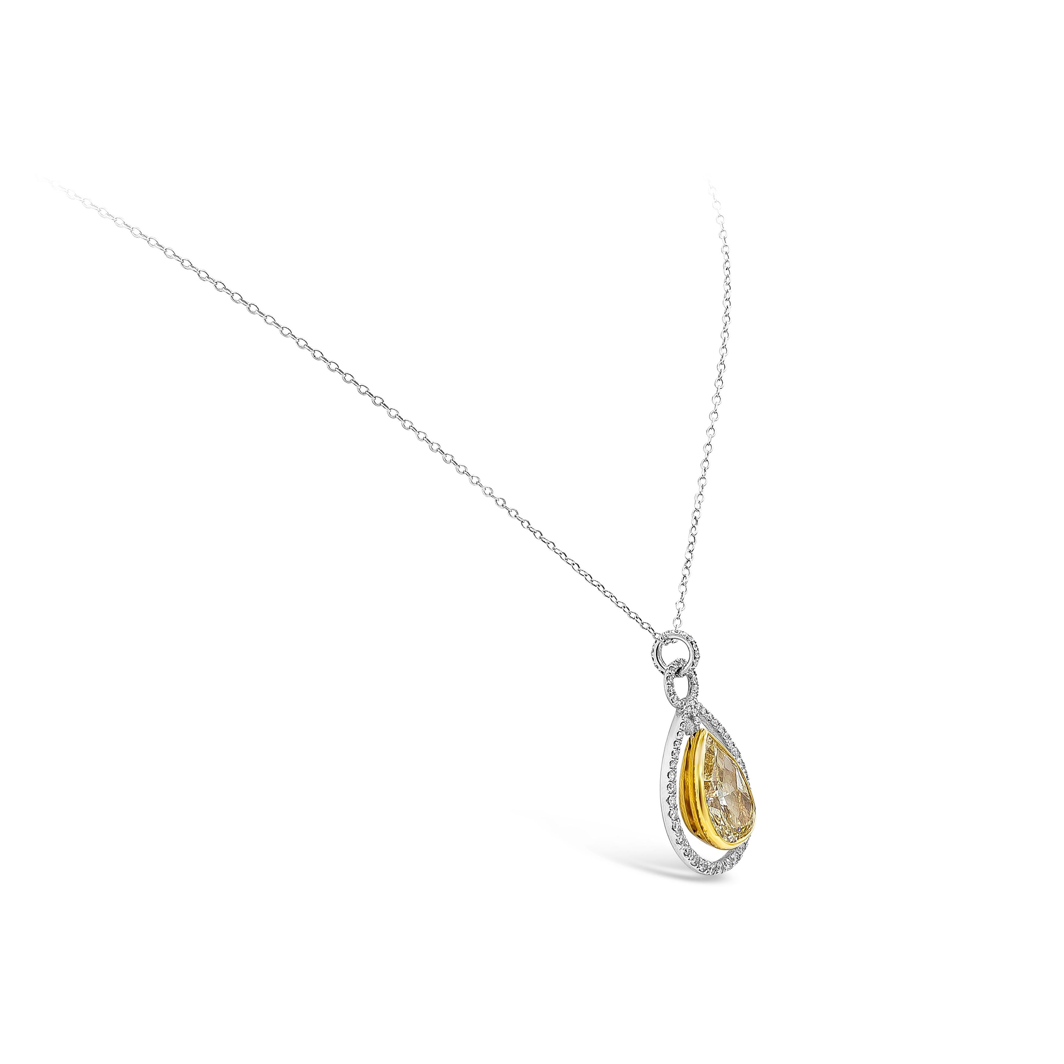 A special piece of jewelry showcasing a GIA certified beautiful pear shape yellow diamond weighing 5.25 carats, Y-Z color and Internally flawless in clarity. Set in a unique open-work halo design made in yellow gold and platinum. Suspended on an