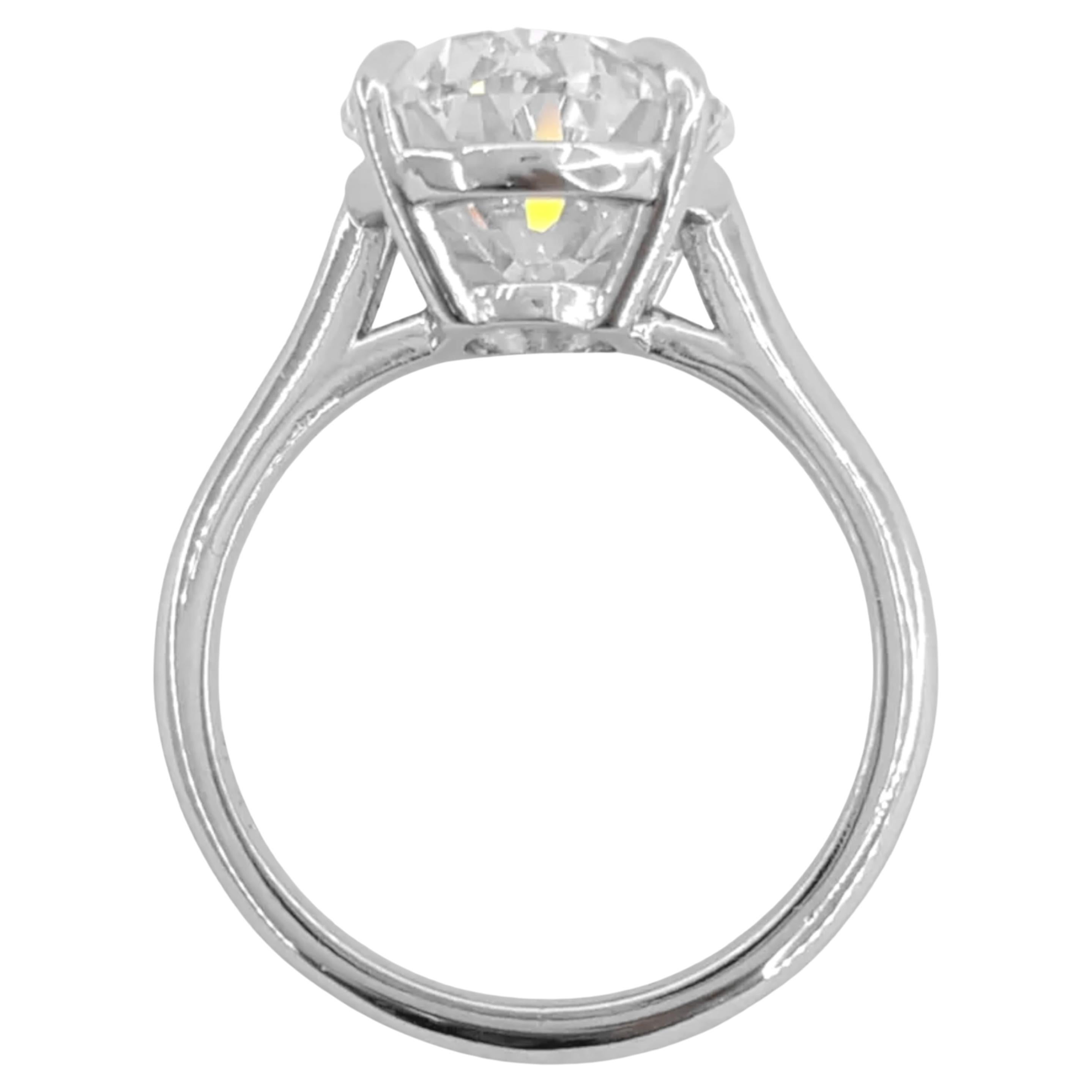 stunning engagement ring features a magnificent oval brilliant cut diamond at its center, weighing 5.26 carats. Graded as E in color and internally flawless in clarity, this diamond exhibits exceptional qualities including an excellent cut, very