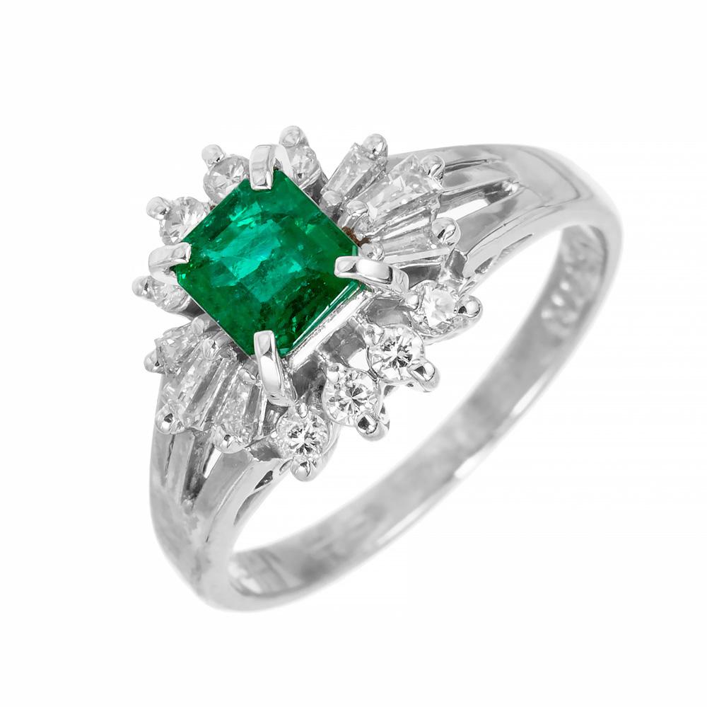 Vintage 1950's emerald and diamond princess style engagement ring. The rich green GIA certified octagonal cut center emerald is certified natural and F1 clarity enhancement only. Mounted in a platinum setting and beautifully accented with 6 tapered