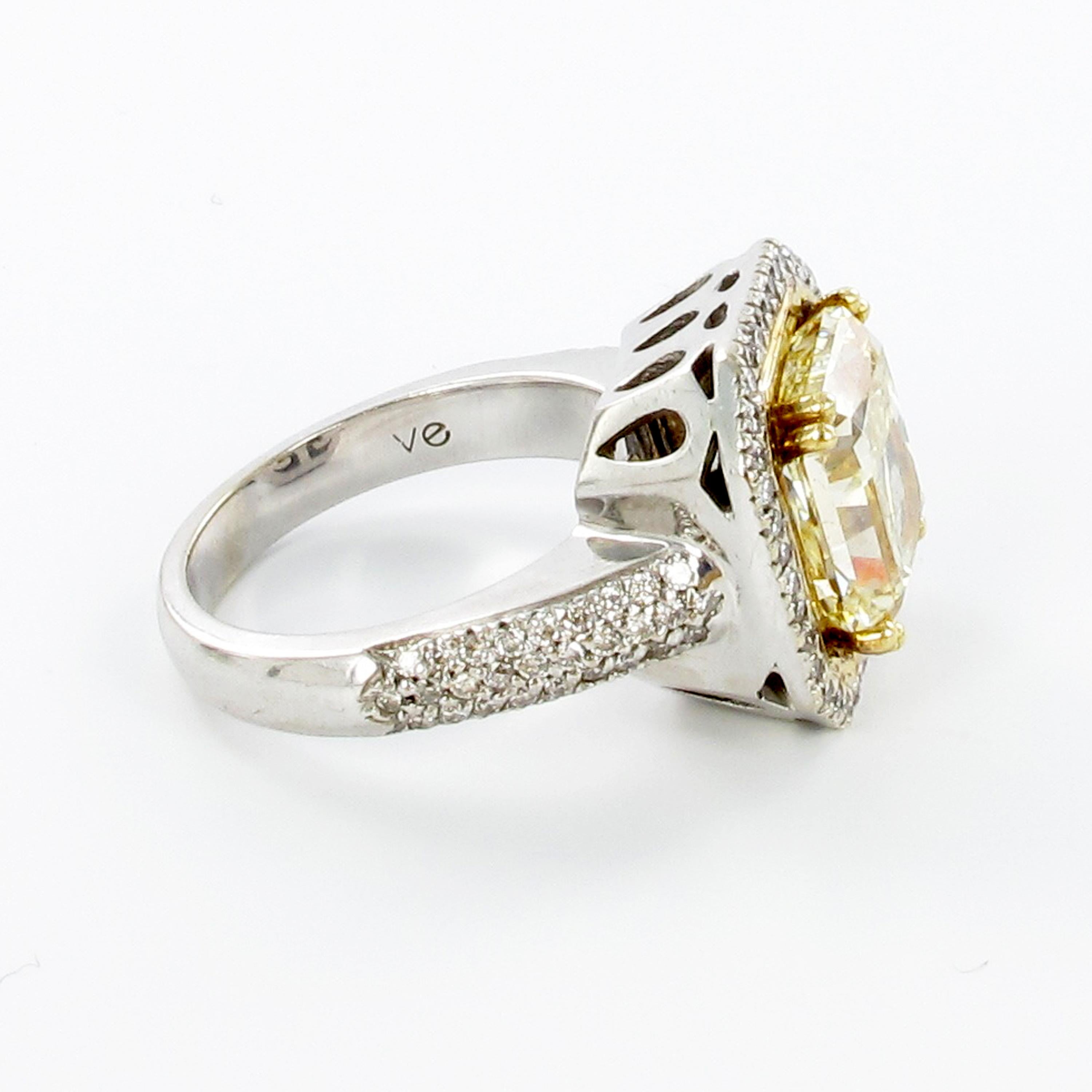 Modern look in gold 750. While the ring is held in white gold, the GIA certified center diamond of 5.30 carats is set in yellow gold prongs, embeded in a yellow gold frame, to support the yellow color of the stone. GIA specifiacations are X/Y/Z