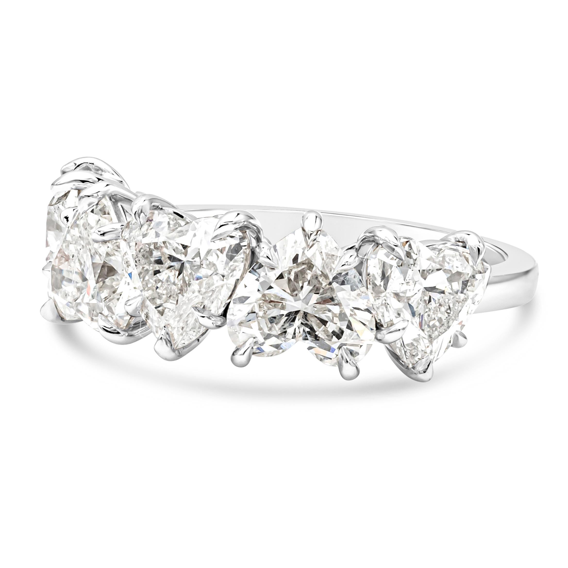 A classic and beautiful five-stone wedding band showcasing five brilliant heart shape diamonds weighing 5.31 carats total certified by GIA as H-J color and SI2-I1 in clarity, set in a timeless five prong basket setting. Finely made in Platinum and