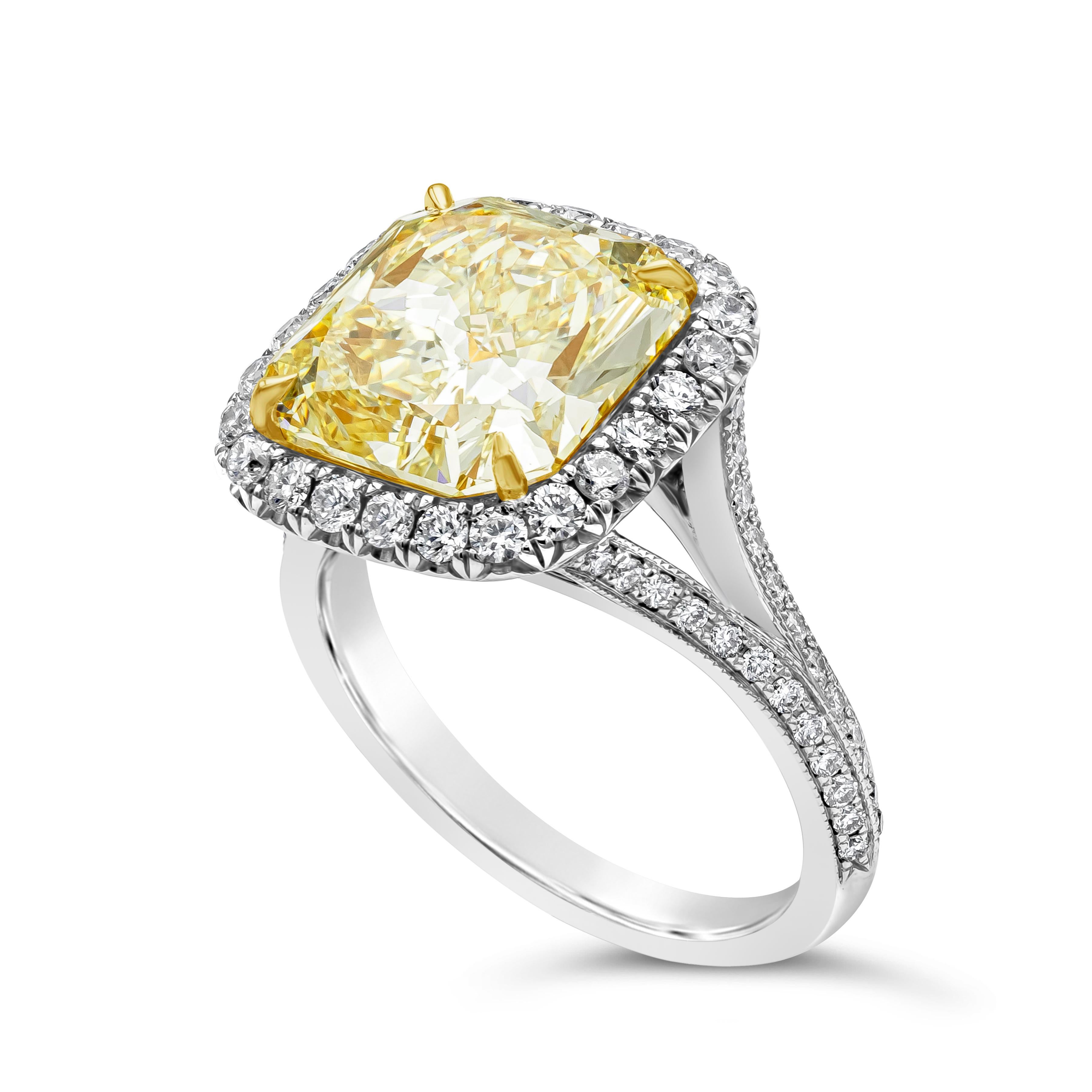 Features a GIA Certified color-rich radiant cut fancy yellow diamond weighing 5.32 carat and VS1 in clarity. Set in a yellow gold four prong setting. Surrounded by a single row of round brilliant diamonds weighing 0.85 carats total, G color, VS2 in