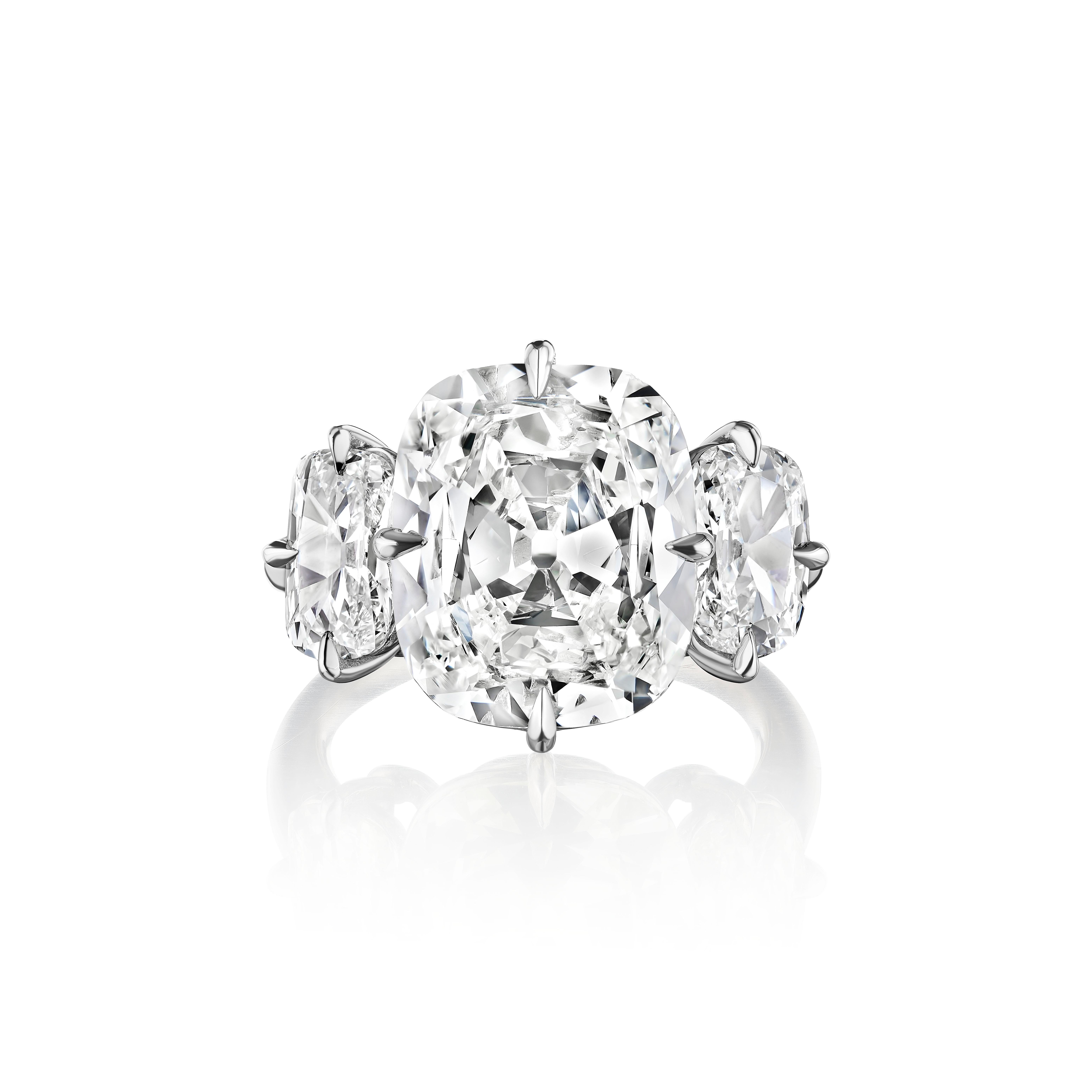 The Ultimate Antique Cushion Cut Diamond Ring.

Centered upon a 5.36 Carat True Antique Cushion, with GIA Certificate stating the stone is K color, VS2 clarity.
Flanked by elongated Cushions weighing 1.31 Carats.
Set in Platinum.

Stone spreads like