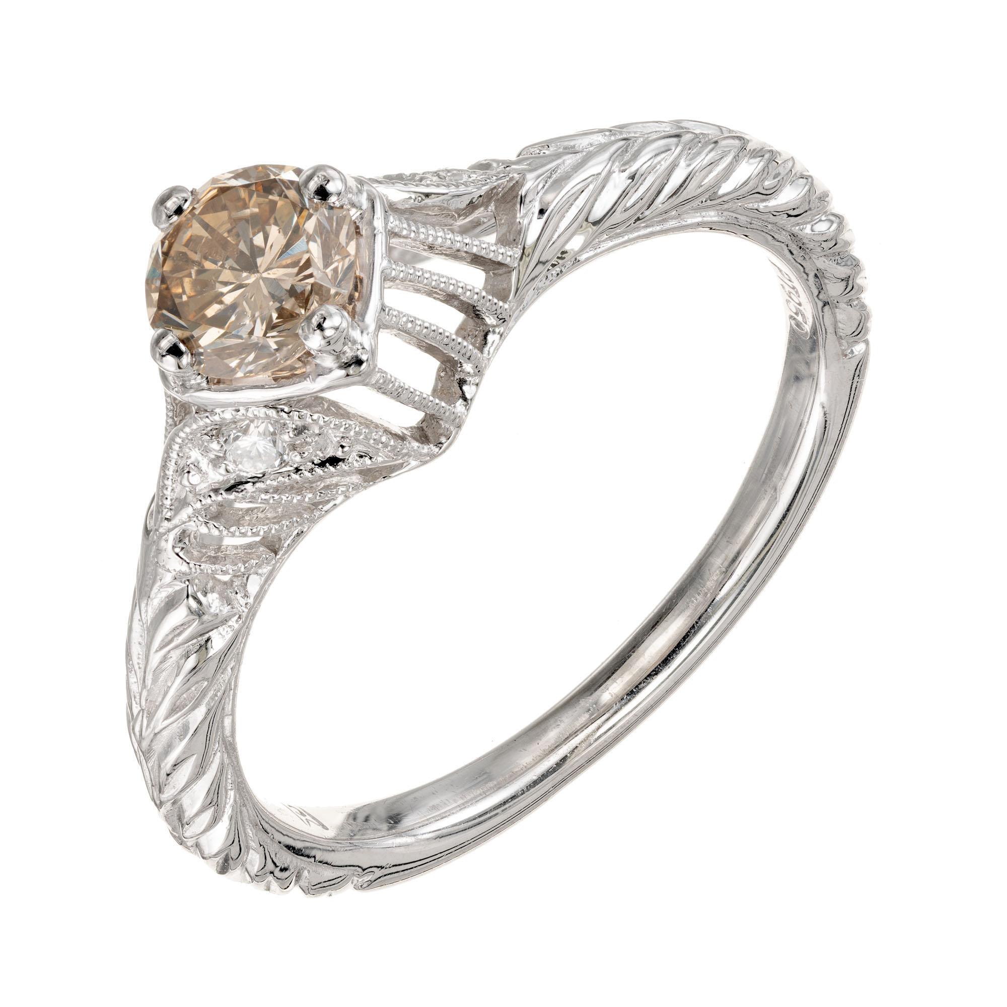 Transitional cut GIA certified natural light brown diamond. Vintage inspired platinum open work setting with round diamond accents. 

1 round brilliant cut light brown diamond, approx. .54cts W I  GIA Certificate # 2155386146
2 round diamonds,