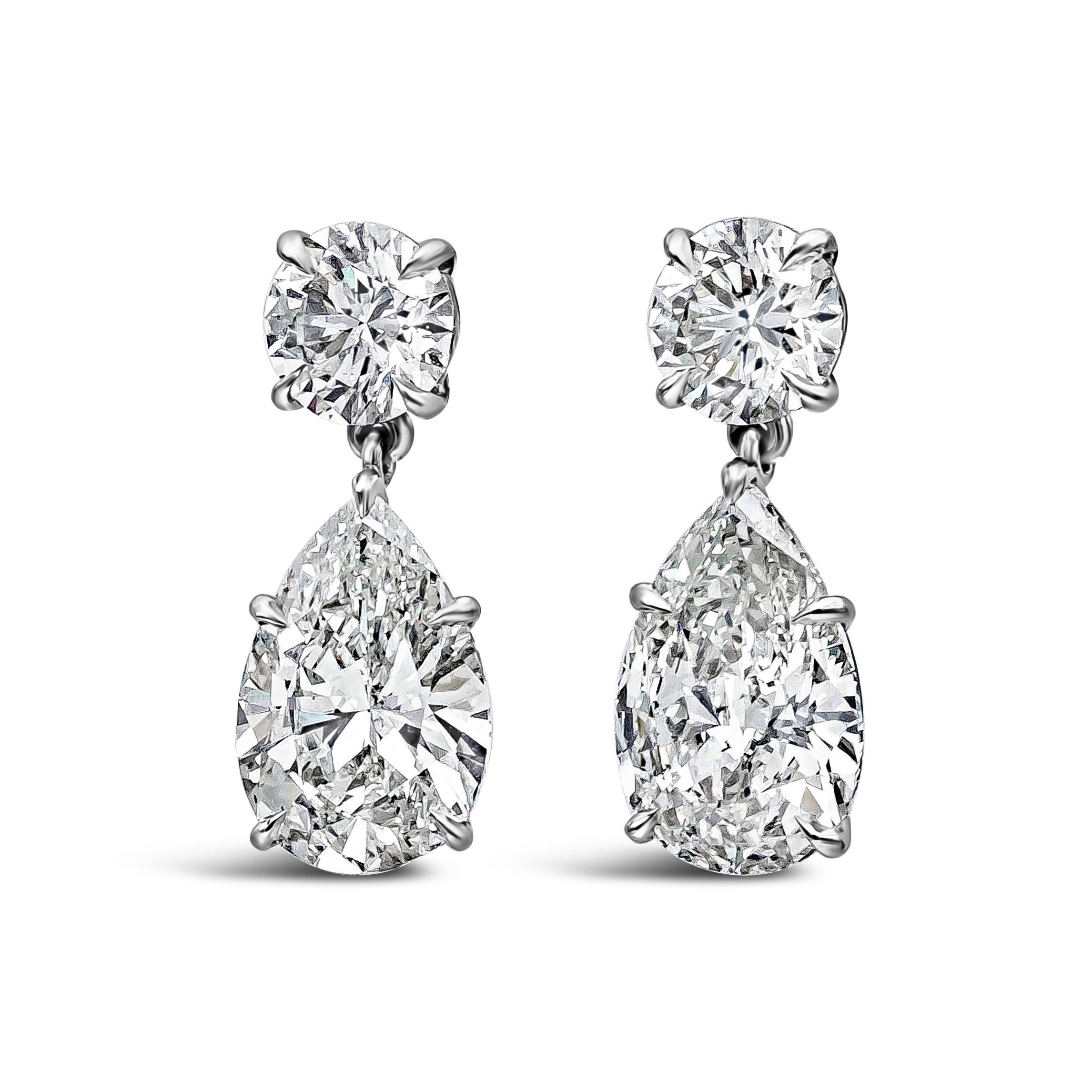 A classy pair of dangle earrings featuring a GIA Certified pear shape diamond drop suspended on a GIA Certified round brilliant diamond. Pear shape diamonds weigh 4.02 carats total, G-H Color and SI1 in Clarity. Round diamonds weigh 1.41 carats