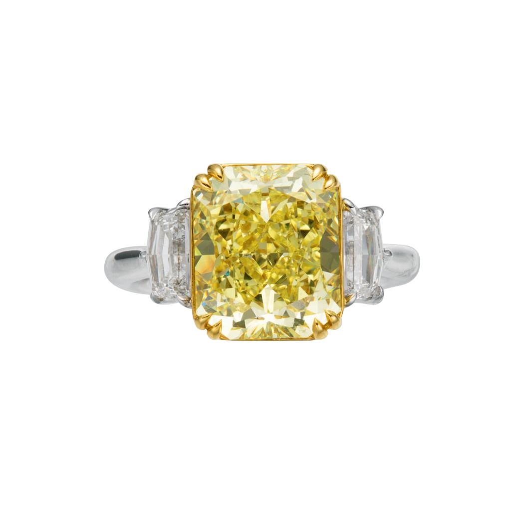 5.46ct Cushion Cut Natural Fancy Yellow Diamond Ring, a beacon of luxury and sophistication. This extraordinary piece, meticulously crafted in 18kt gold, is a testament to refined taste and timeless beauty. At the heart of the design is a stunning