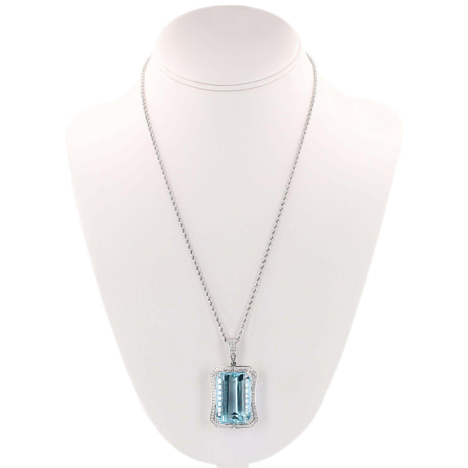 One electronically tested platinum ladies cast & assembled aquamarine and diamond pendant with chain. Condition is new, good workmanship. The pendant features an aquamarine set within a stylized diamond bezel, completed by a hinged diamond set bail.