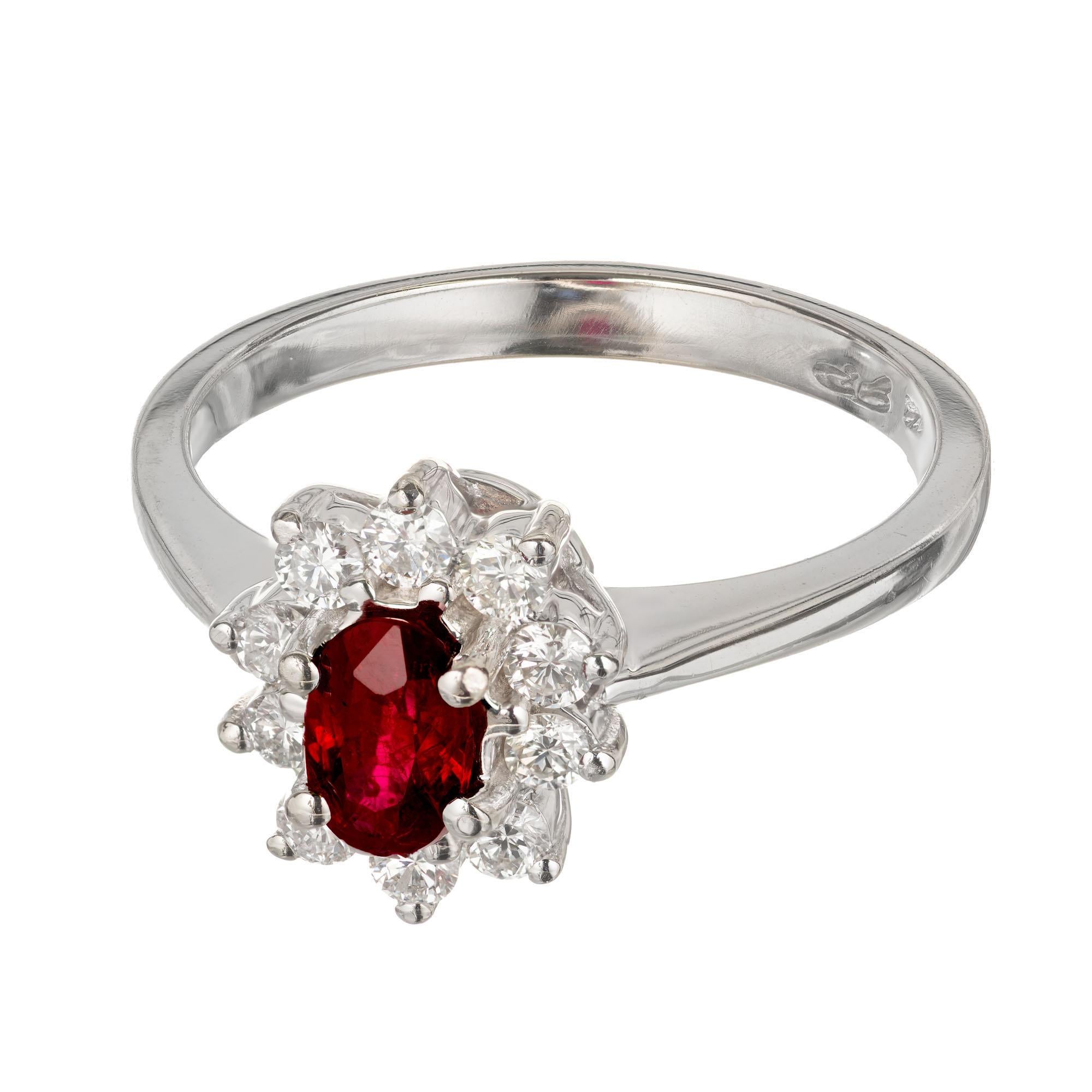 Ruby and diamond engagement ring. Oval center ruby with a halo of round accent diamonds in a 14k white gold setting.  

1 oval Ruby 5.8 x 3.9 x 2.6mm, approx. total weight .55cts  GIA certificate #1152308217. natural ruby, simple heat treatment and