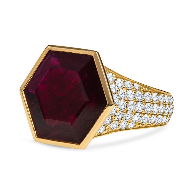 This beautiful and unique ring features a GIA certified bezel set 5.51 carat hexagonal cut natural ruby from Mozambique. It is set in 18 karat yellow gold and accented by 1.15 carat total weight in pave-set round diamonds. This is a very modern