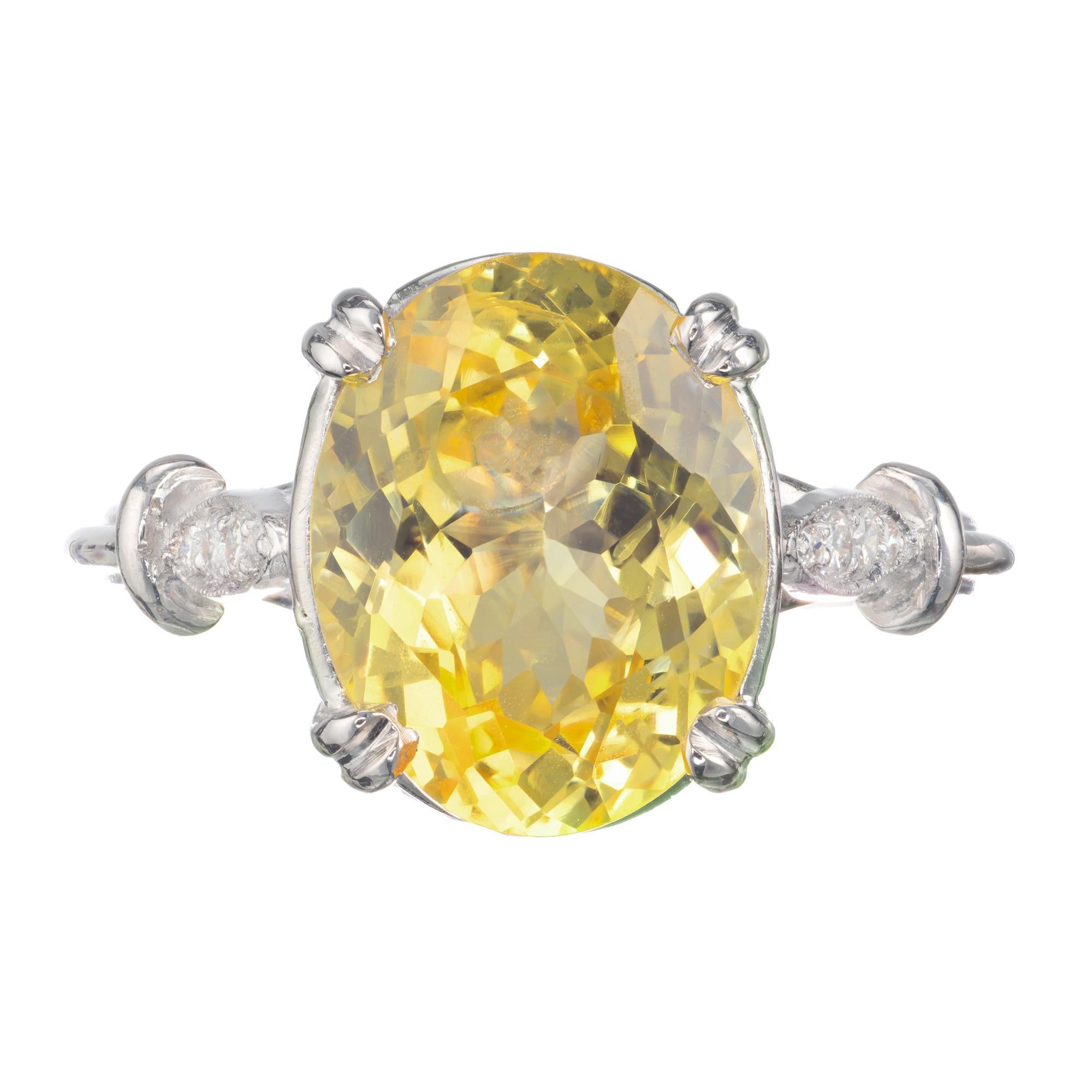1950’s mid-century lemon yellow 5.52 carat oval sapphire and diamond engagement ring. Set in its original handmade platinum setting with eight accent diamonds. Bright yellow GIA Certified oval natural simple heat only, no other enhancements. 

1