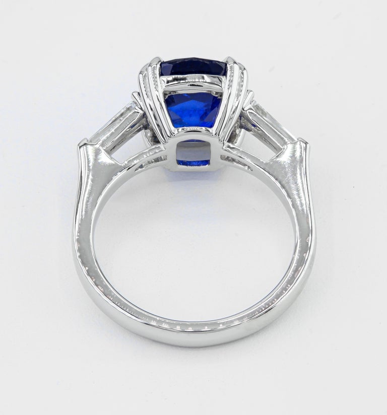 Modern GIA Certified 5.54 Carat Cushion Sapphire Platinum Three Stone Ring For Sale