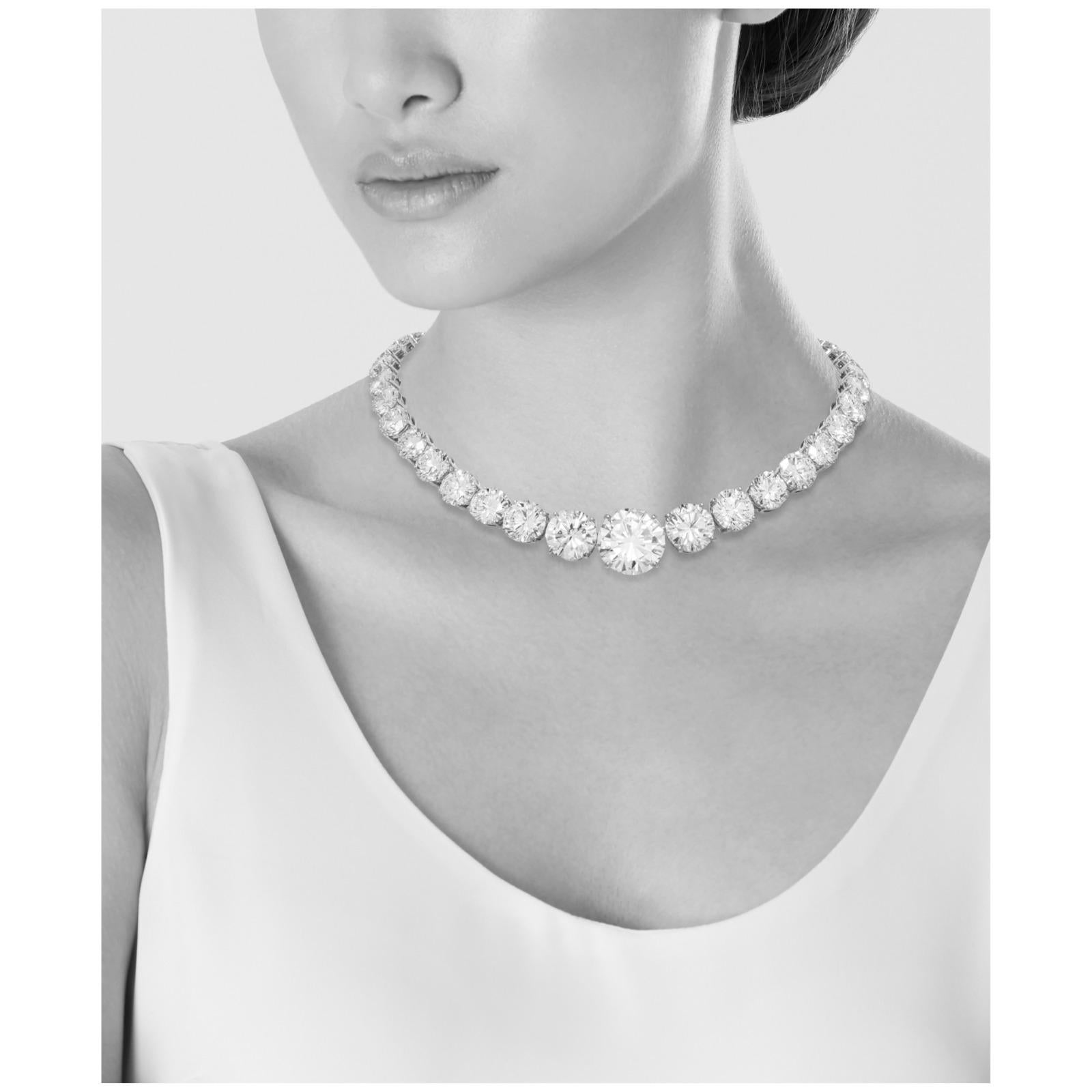 This exquisite necklace features a stunning array of round brilliant-cut diamonds, meticulously crafted to create a radiant centerpiece. The design includes diamonds weighing 15, 7, 6, 5, 5 carats, along with several additional diamonds of 3 carats
