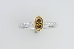 GIA Certified .56 ct Orange Yellow Oval Diamond In 18kt Two Tone Diamond Ring
