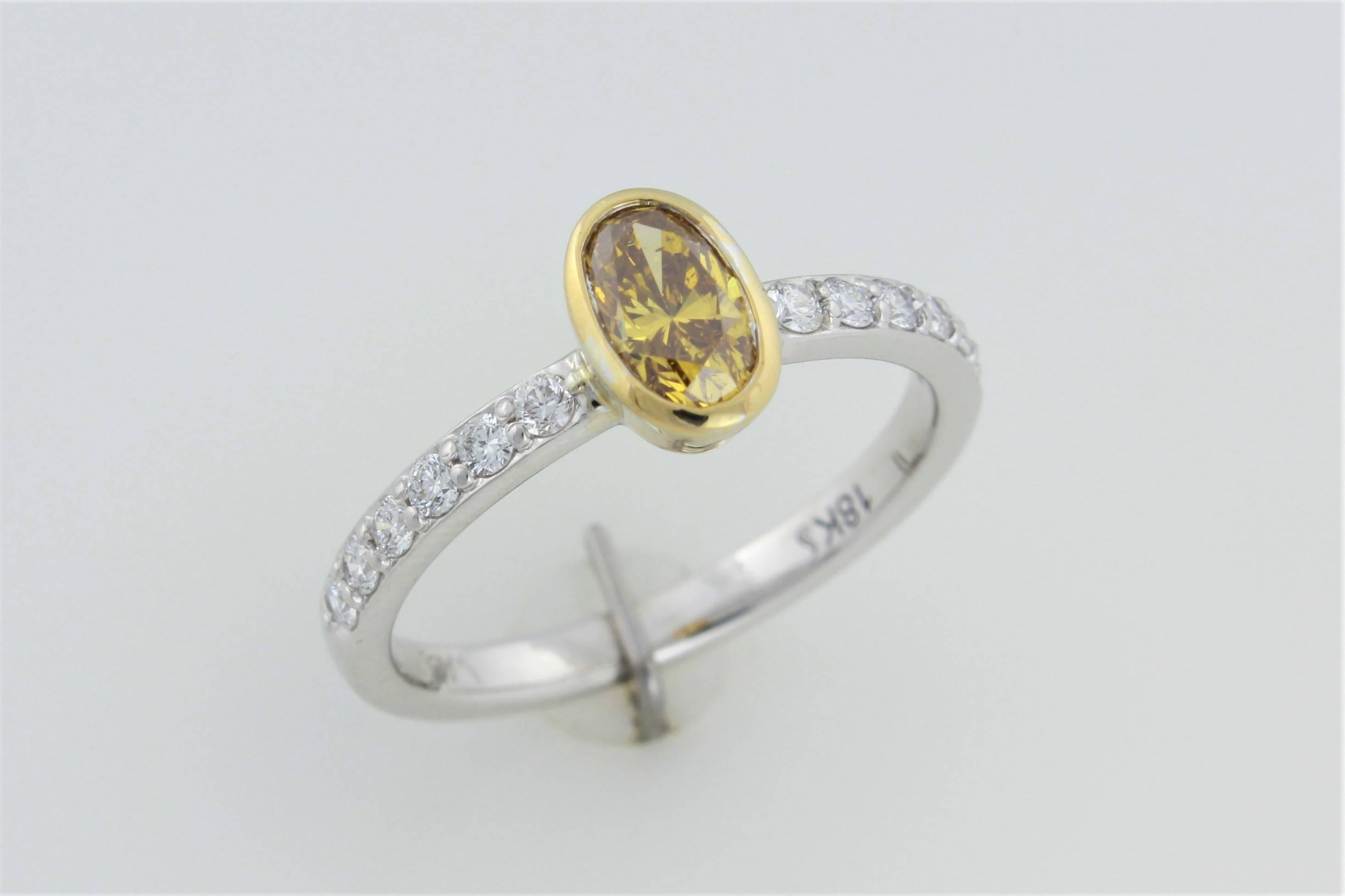 Modern GIA Certified .56 ct Orange Yellow Oval Diamond In 18kt Two Tone Diamond Ring  For Sale