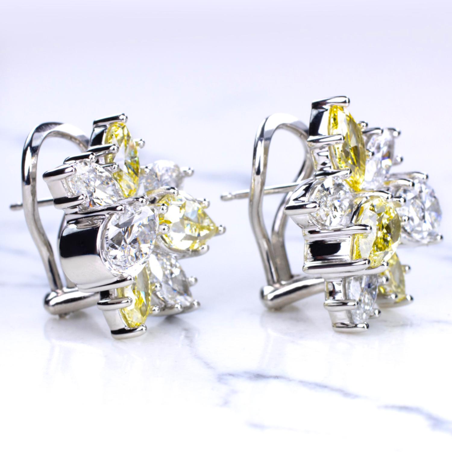 Indulge in the enchanting allure of these GIA Certified 5.60 Carat Fancy Yellow and White Diamond Platinum Cluster Earrings. A symphony of shapes unfolds as marquise and pear diamonds dance together, intricately set in platinum. 

These earrings are