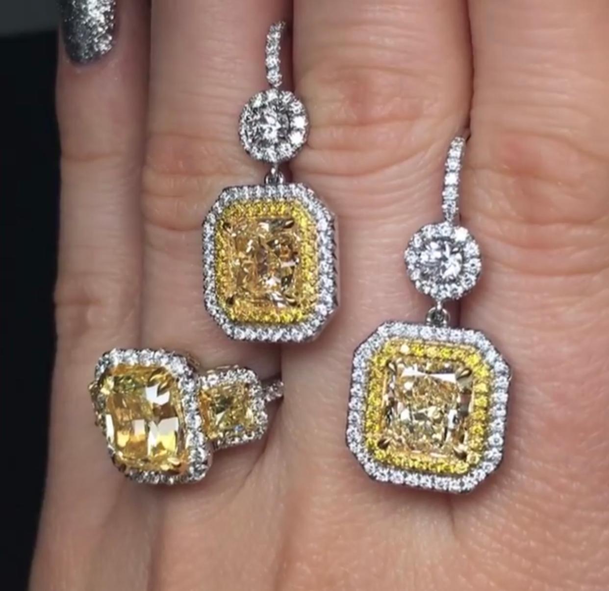 18K White Gold Double halo yellow diamond earrings. Two yellow diamonds are GIA Certified Fancy Light Yellow Diamonds, VS in Clarity, surrounded by 1.75 Carats of round brilliant cut diamonds, F-G in Color VS in Clarity. 
Set in white gold custom