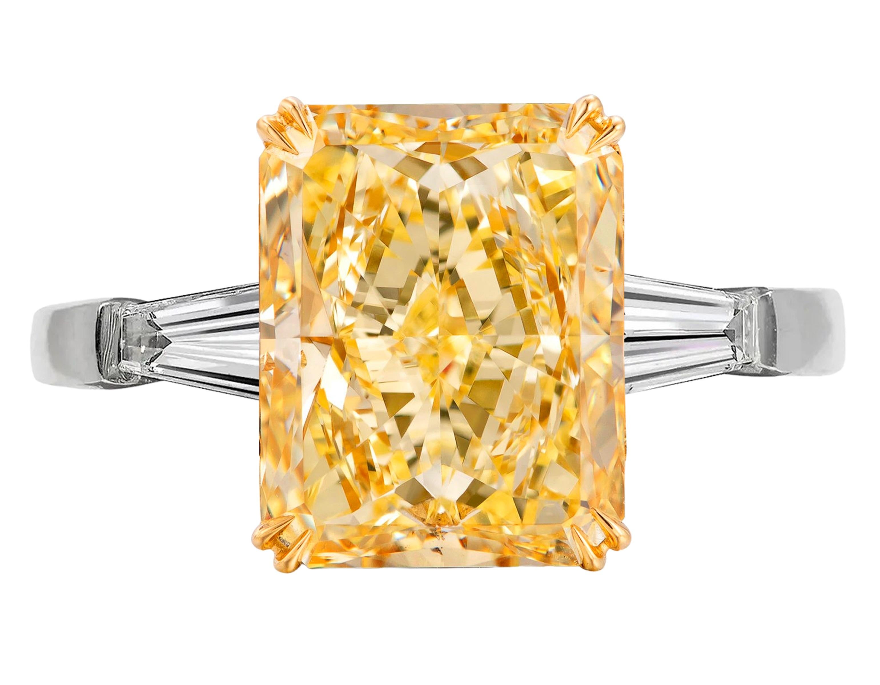 An exqusite radiant diamond weighing 5.65 carats.
The diamond is certified by GIA stating that it's of fancy yellow color, VS1 clarity.
It's accented by two tapered baguette diamonds on both sides weighing a total of 1 carats.
Metal: platinum and