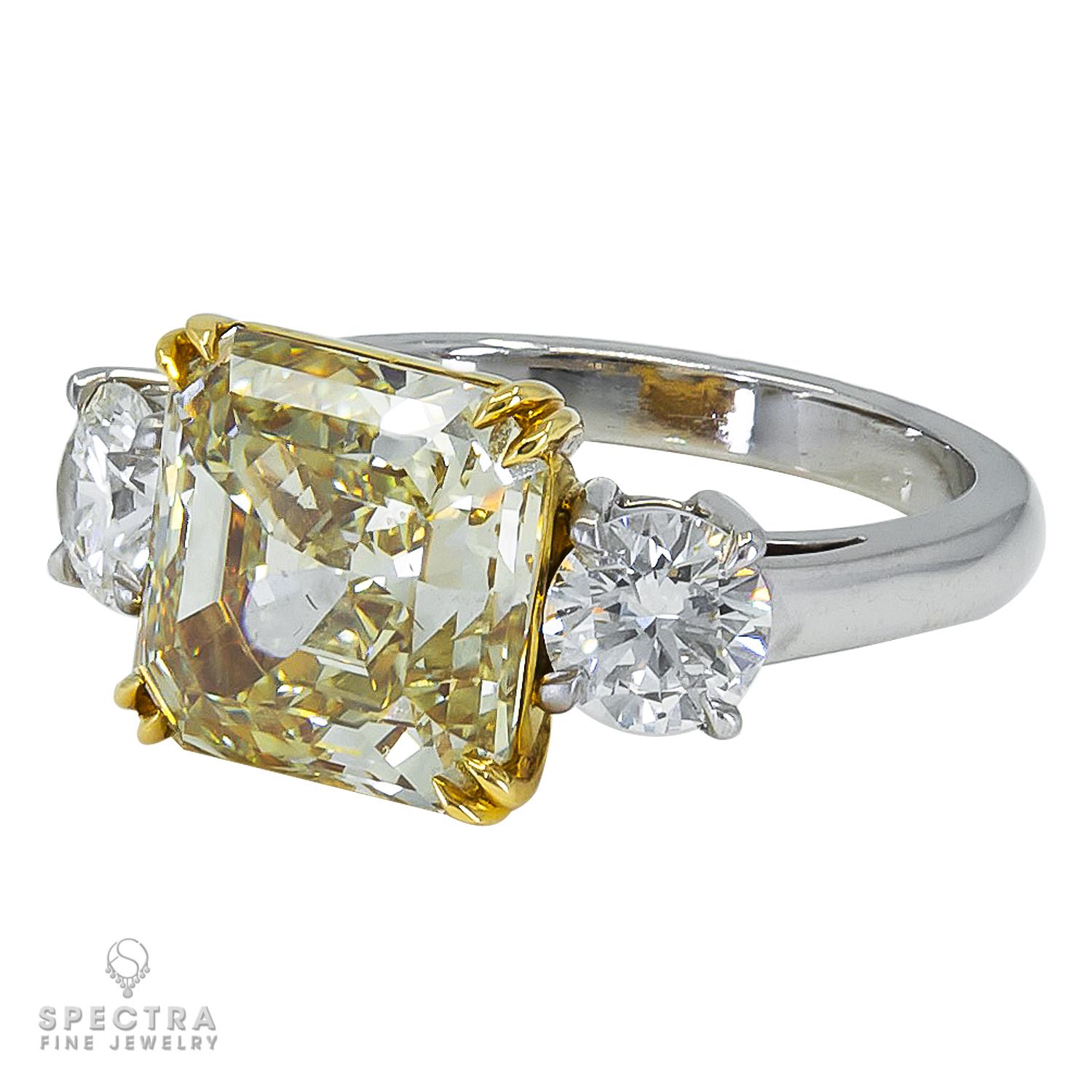 A beautiful cocktail ring set with a square emerald-cut diamond of fancy greenish yellow color and VS1 clarity.
Carat weight is 5.67. Certified by GIA.
Two white round diamonds on both sides:
0.5 carat H SI1 and
0.5 carat H VS2.
Both are certified