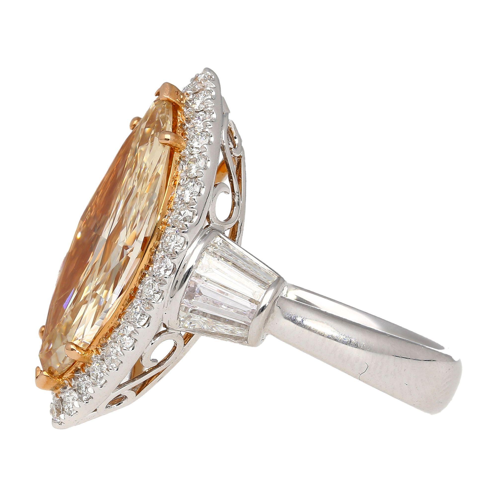 GIA certified fancy light brown-yellow marquise cut diamond ring. Surrounded by a white diamond halo and 8 baguette cut near colorless diamond side stones on the ring shank. The center stone features a unique color mix of yellow and brown that