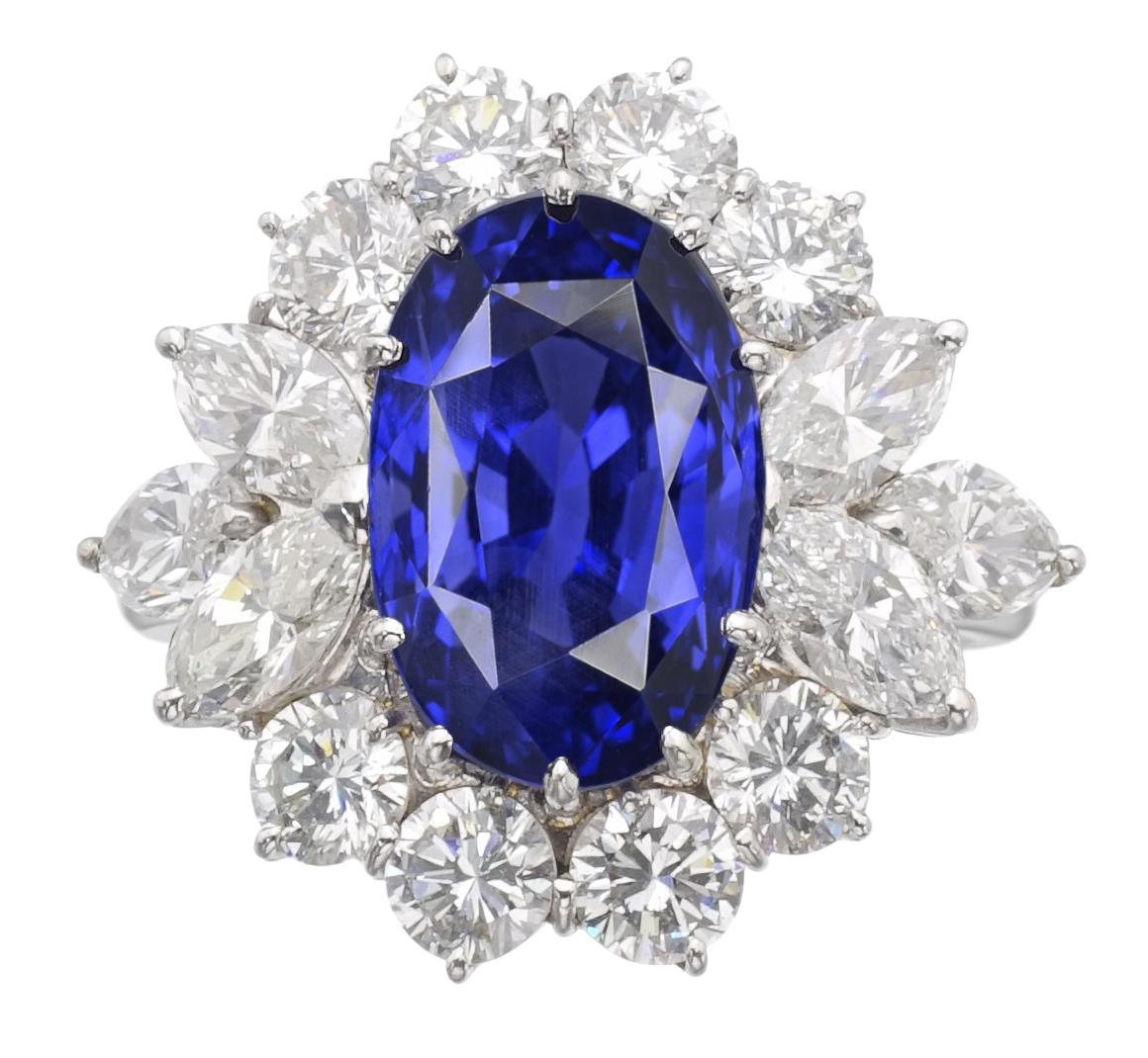 This lovely rectangular oval-cut unheated Ceylon blue sapphire weighing 5.72 carats, is framed with a halo of 8 round brilliant-cut diamonds and 5 pear cut diamonds, totaling approximately 1.50 carats. 

Set in platinum, Accompanied by GIA the