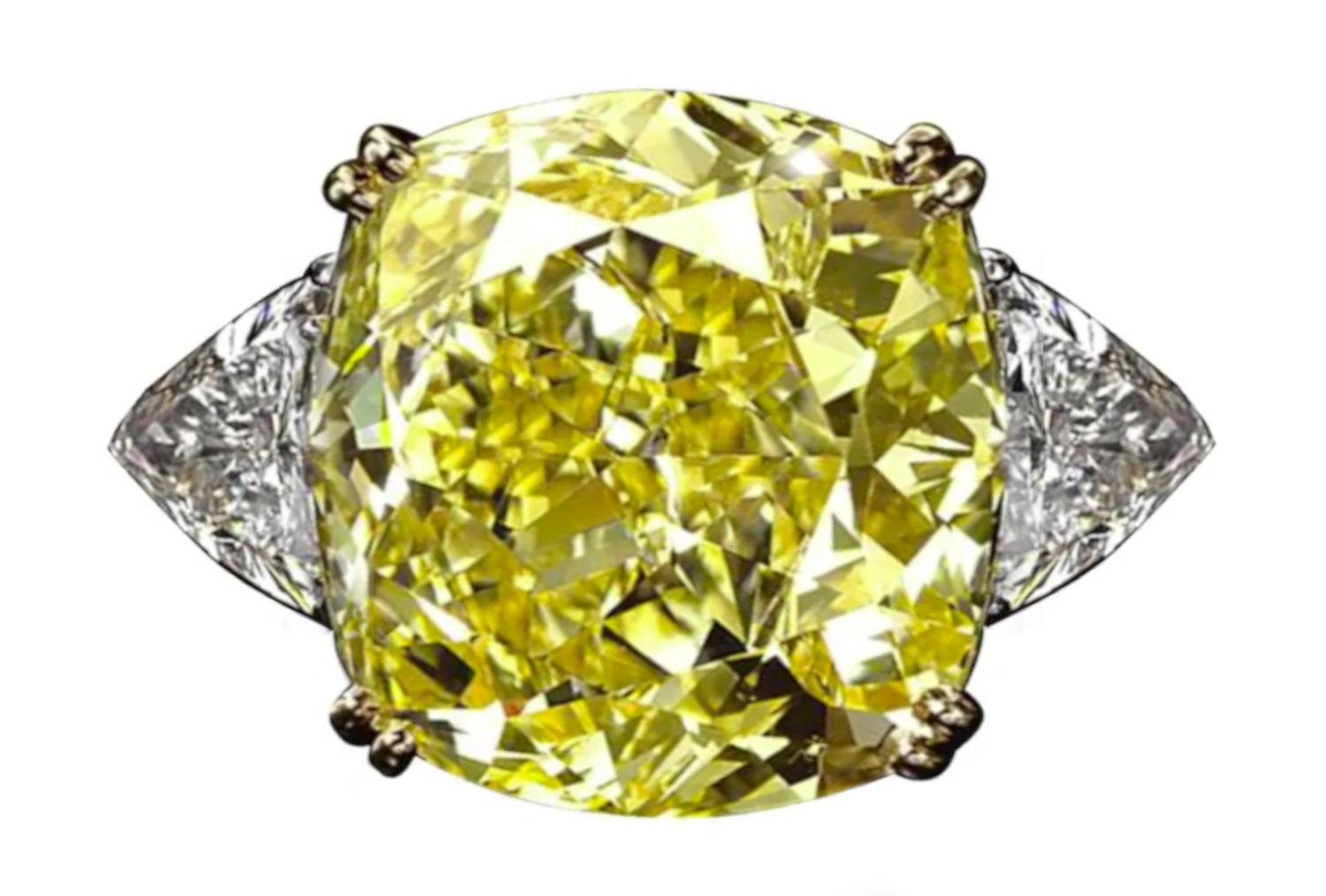 This exquisite ring showcases a stunning 5.76 carat cushion cut diamond with a GIA-certified Fancy Yellow color grade, radiating warmth and brilliance.

The diamond, with an impressive VVS1 clarity, exhibits exceptional fire and luminosity, thanks