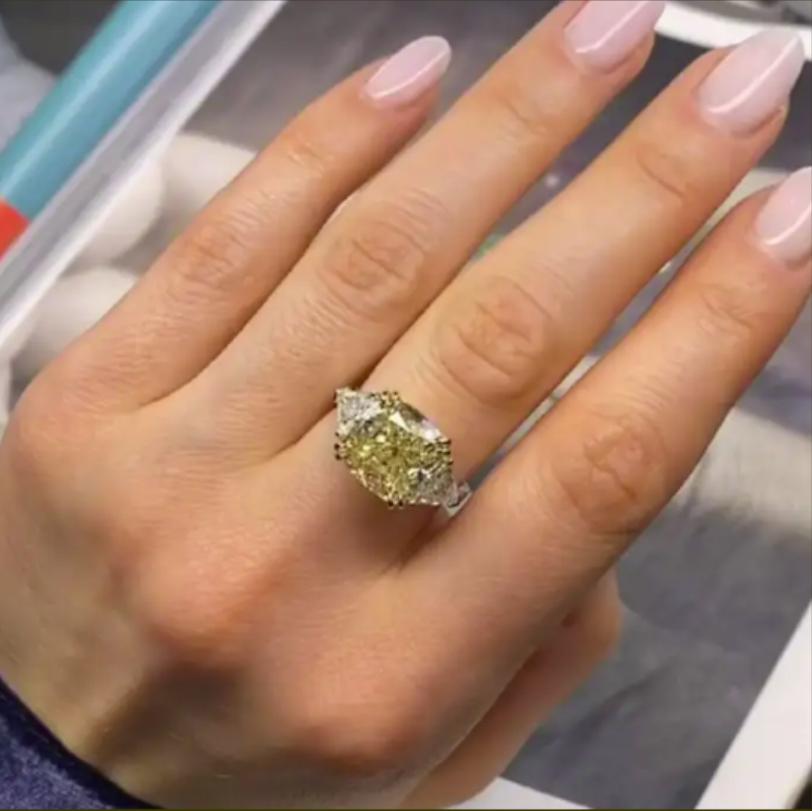 Contemporary GIA Certified 5.76 Carat Fancy Yellow Cushion Cut Diamond Ring with Trillion For Sale