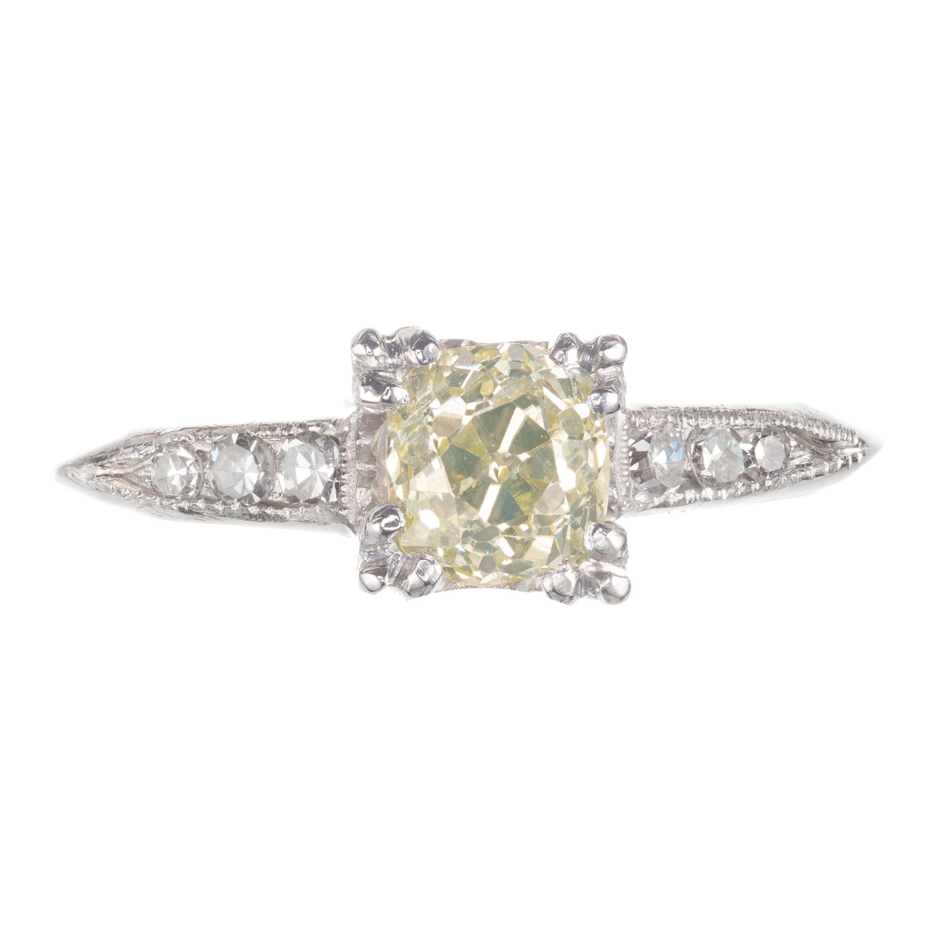 Original natural yellow and white diamond engagement ring. Old mine cut center stone with six single cut accent diamonds in a platinum setting. GIA certified. 

1 old mine cut fancy green/yellow SI diamond, Approximate .58cts GIA Certificate #