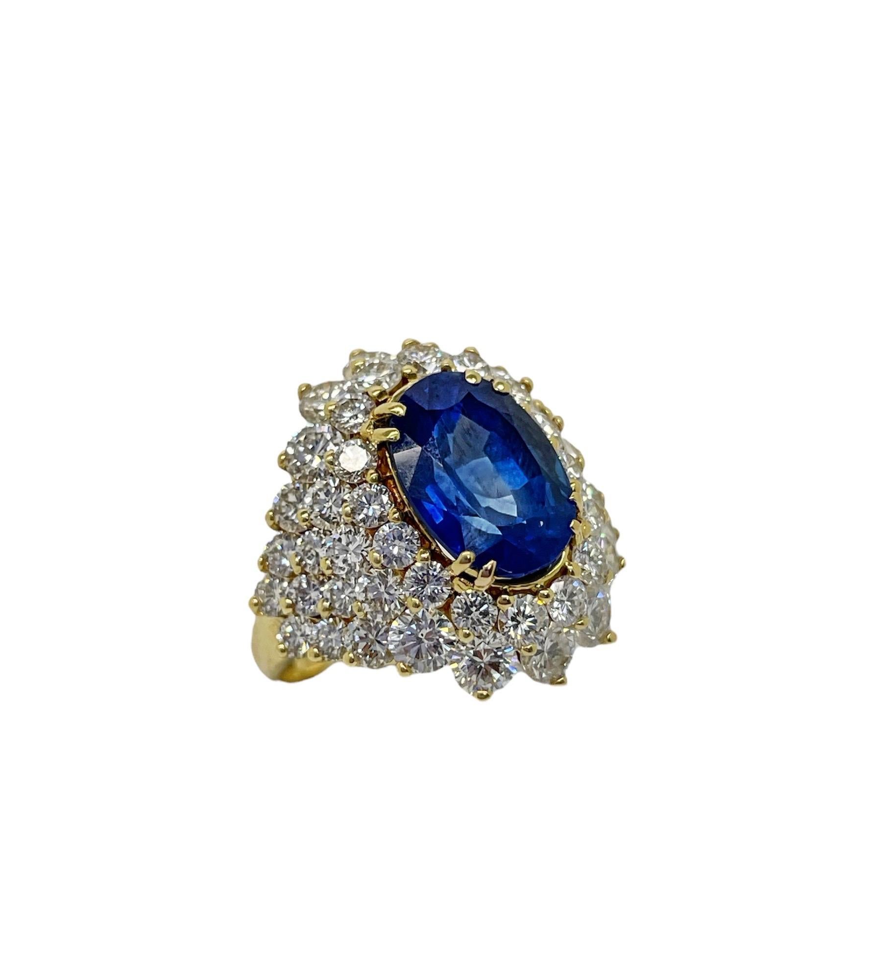This stunning ring contains an oval mixed cut Ceylon sapphire weighing 5.82 carats surrounded by 50 top quality round brilliant cut diamonds weighing approximately 4.50 carats total. Mounted in a beautifully made 18 karat gold mounting.

Ring size 6