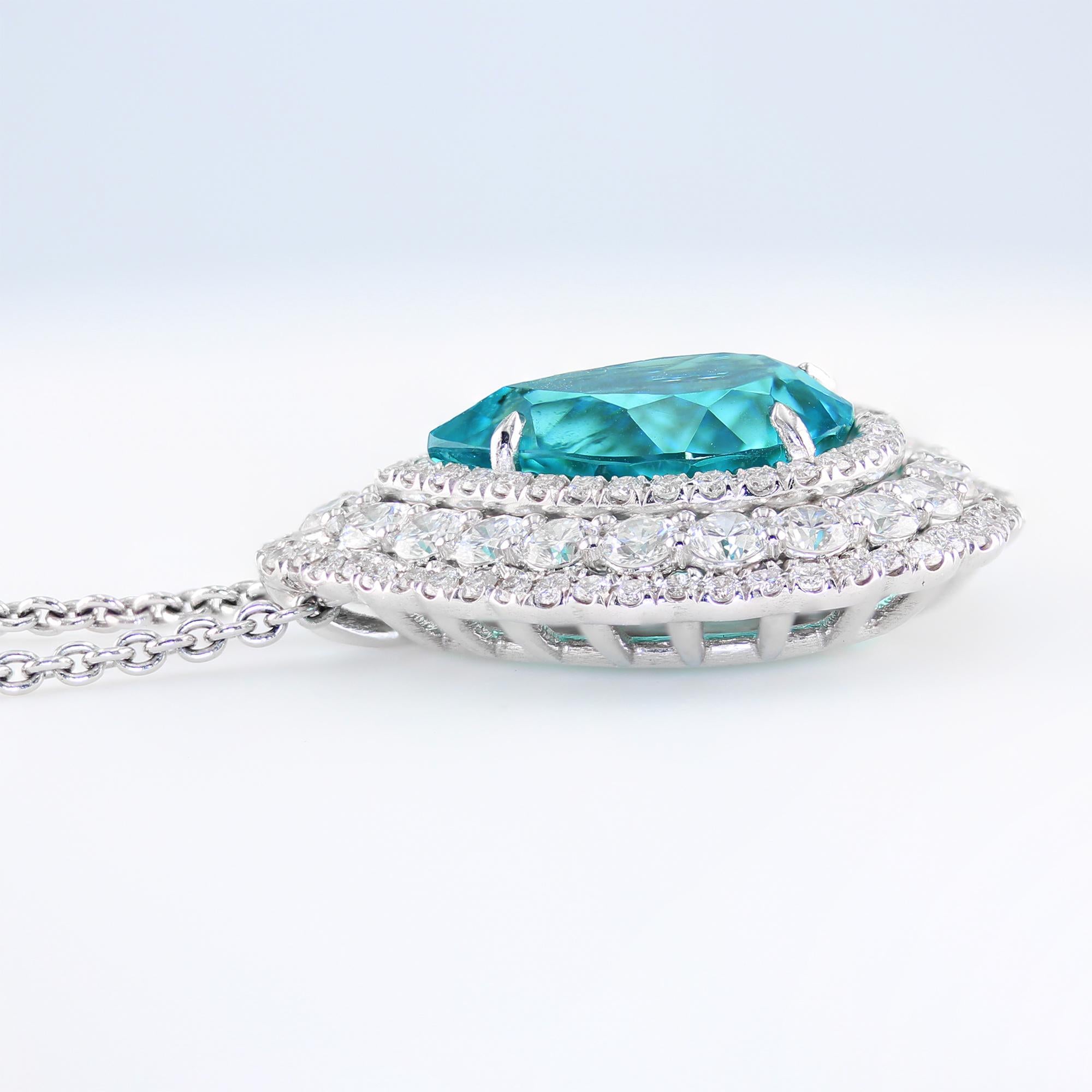 5.86 carat pear-shape Brazilian Paraiba Tourmaline, surrounded by 1.95 carat diamond halo. 

The vibrant and extraordinary color of this one-of-a-kind Brazilian Paraiba makes one feel unique, classy and special while wearing it. It is the perfect