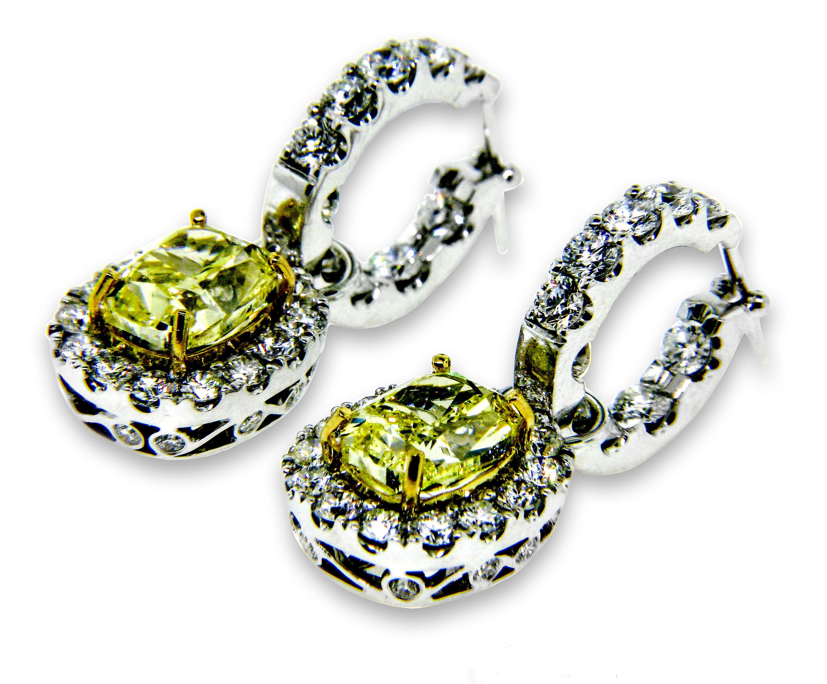 18 karat White Gold hoop earrings, designed by world-renowned jewelry designer, Danuta, with detachable pendants which are set with two GIA Certified Oval Fancy Intense Yellow/VS2 Diamonds weighing 3.03 carats and 2.83 carats with 1.80 carat total