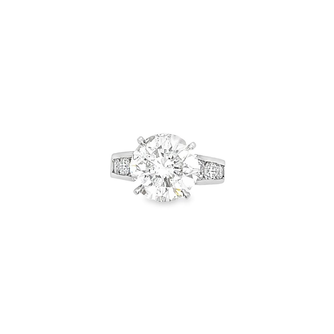 You won't find another engagement ring like this one. It boasts a breathtaking 5.92 Carat natural diamond, certified by GIA. The platinum setting is encrusted with diamonds on both sides, running halfway around the ring. This ring is guaranteed to