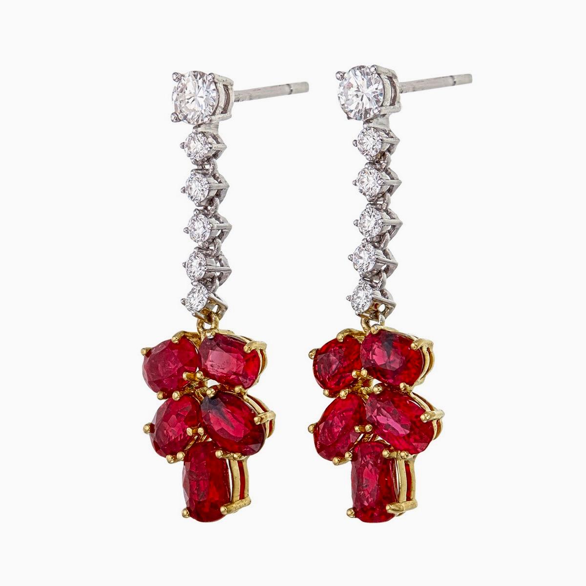 These beautiful dangle earrings, made in ruby and diamonds is handcrafted by Rewa jewels in 18 karat white gold.

The exclusive earrings are decorated with 10 pieces of Burma rubies weighing approximately 5.96 carat. There are 18 pieces of oval