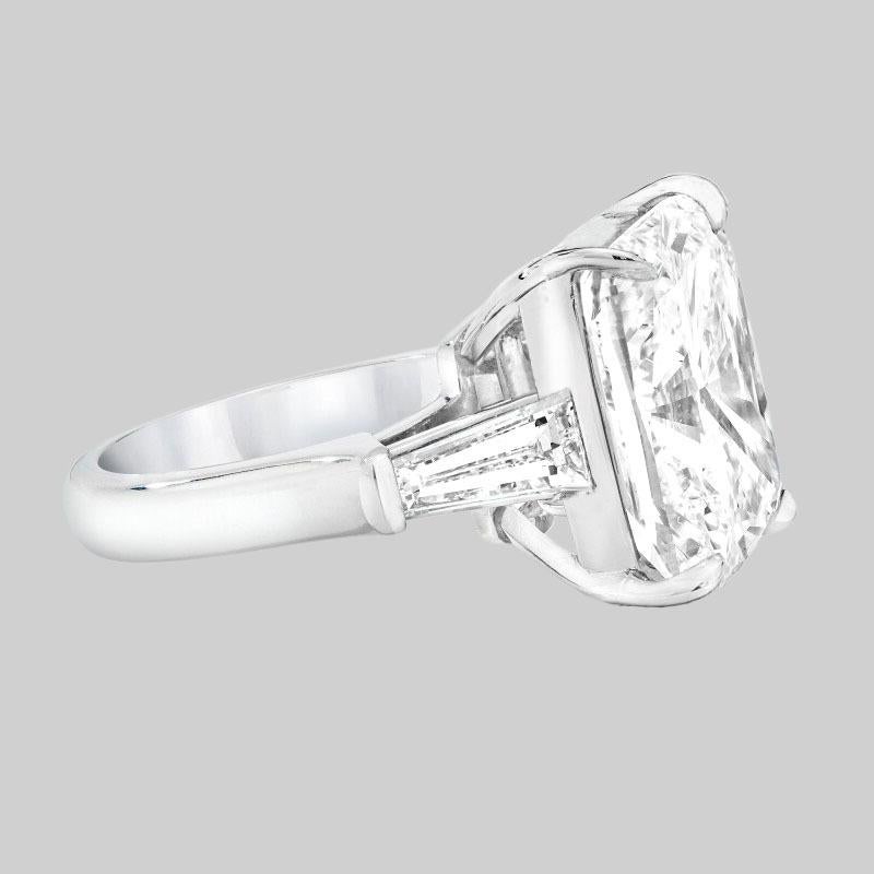 This exquisite 18k white gold ring presents a breathtaking centerpiece: a 6 carat GIA-certified Cushion briliant diamond. 

The diamond boasts a remarkable E color and FLAWLESS clarity, ensuring a dazzling display of brilliance and clarity. Expertly