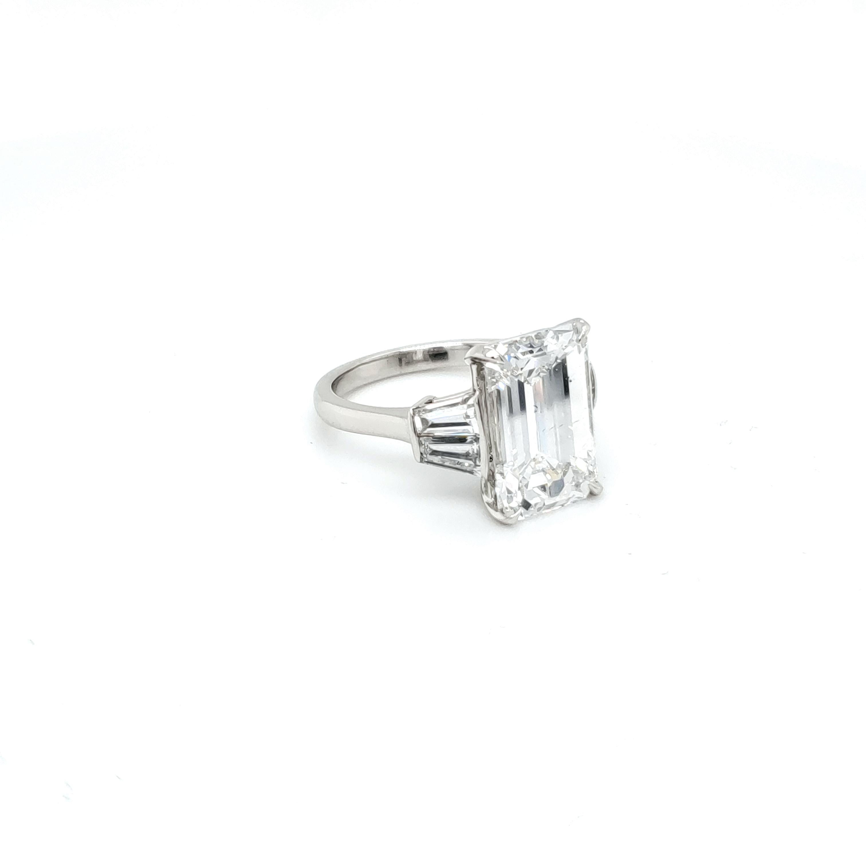GIA Certified 6.03 carat Diamond with an emerald cut set in four pointed prongs. The center diamond is accompanied by a GIA certificate, diamond report. The GIA report number is 5202555415. The diamond is F color and SI-1 clarity. VERY white