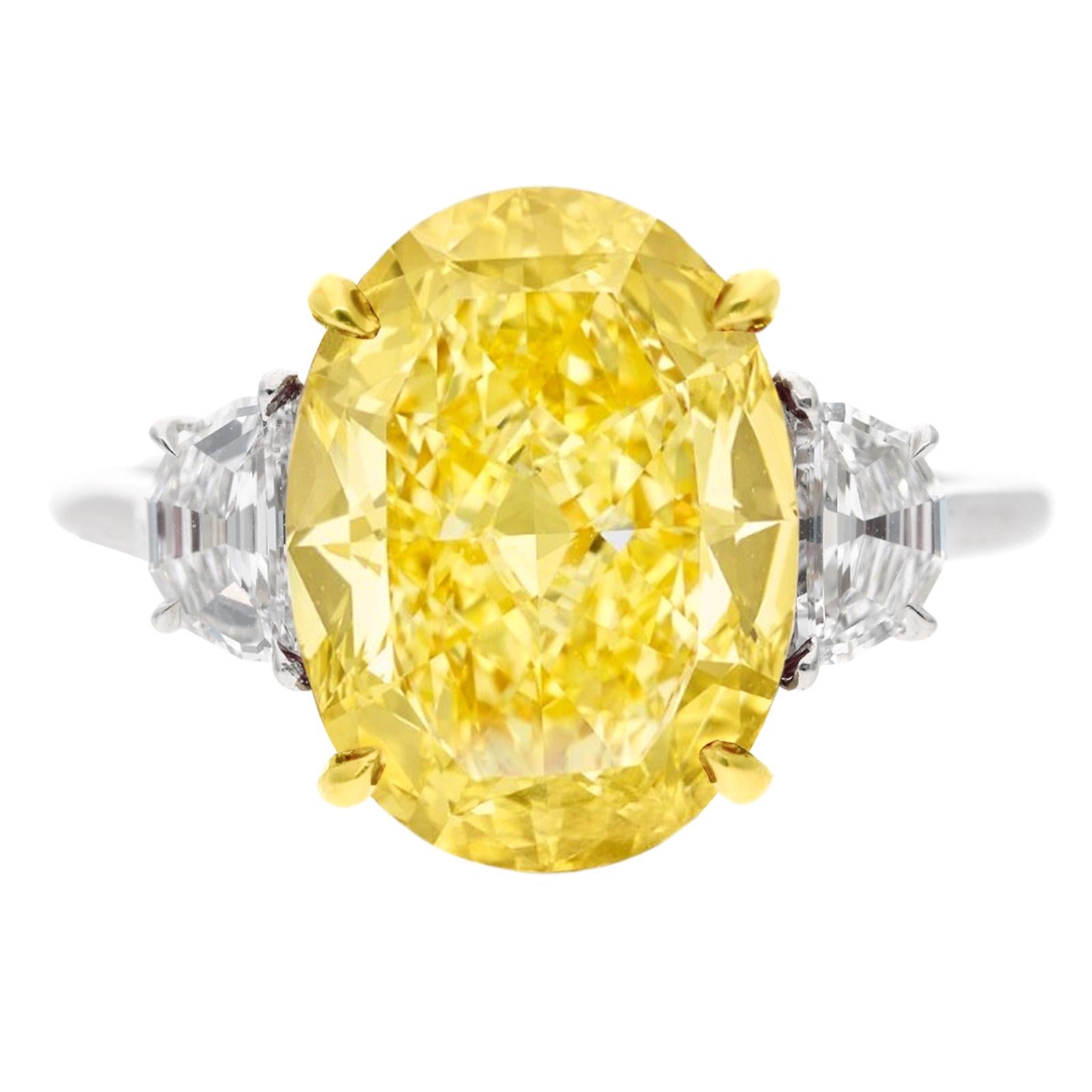 Contemporary GIA Certified 6.34 Carat Fancy Yellow Oval Cut Diamond IF Clarity Ring For Sale