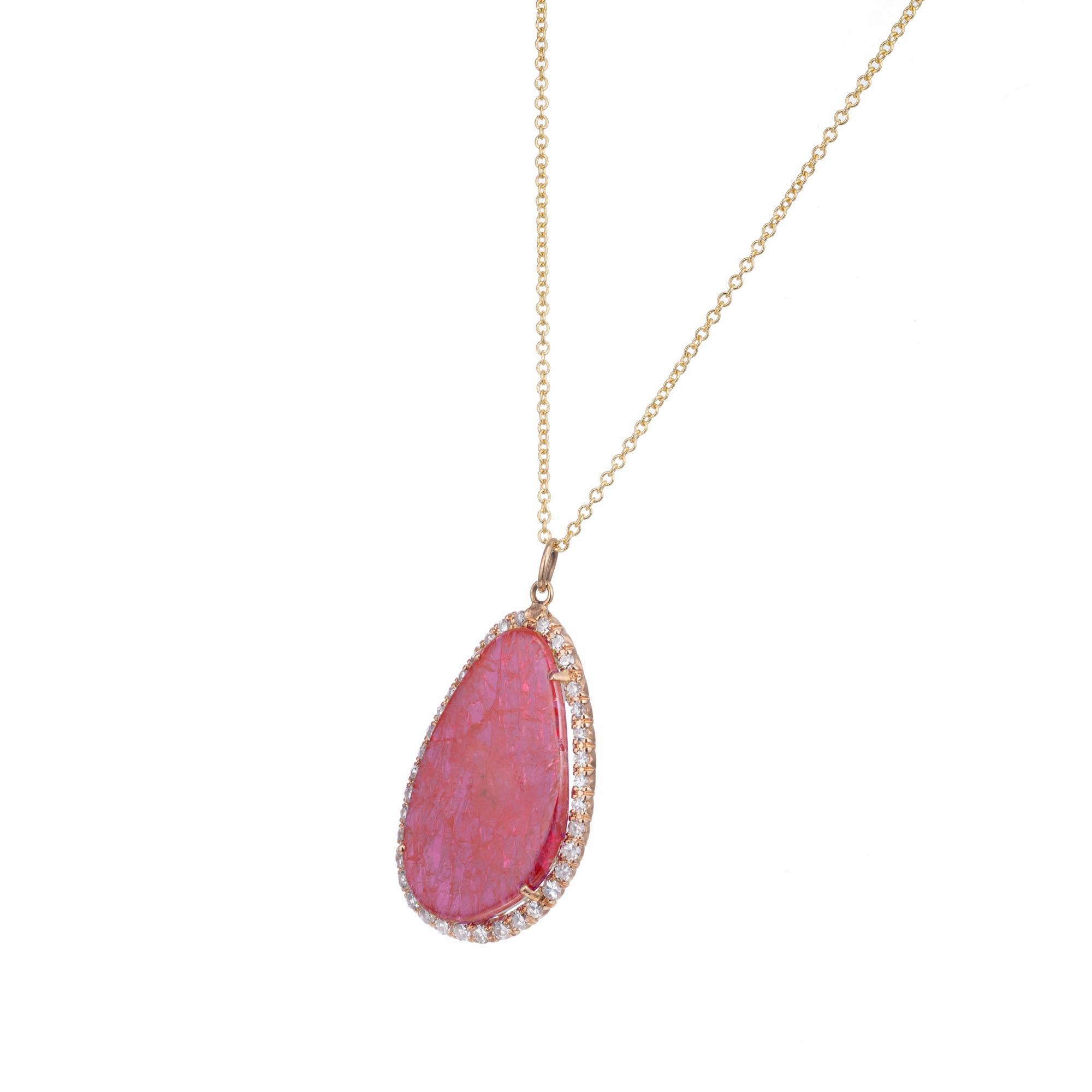 Rare natural untreated bright purplish pink sapphire slice and diamond pendant necklace. GIA certified center slice with a halo of 36 round accent diamonds set in 18k yellow gold.

1 freeform purplish pink cabochon sapphire MI, approx. 6.00cts GIA