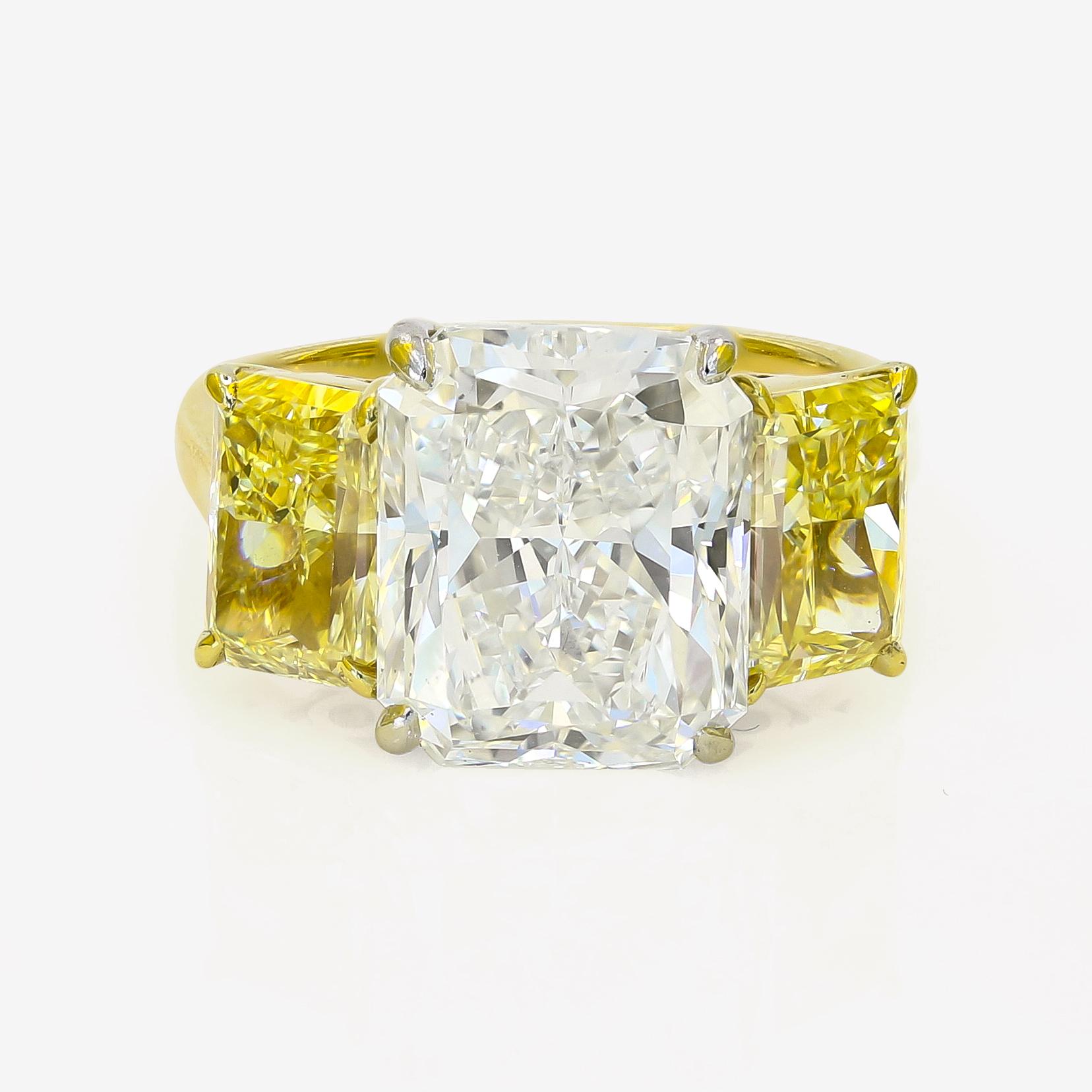 This stunning Lester Lampert original is an eye catcher!  The 6.00cts. radiant cut center is I in color and VS2 in clarity. It has two fancy yellow radiant cut diamonds, one on each side, that total 3.09cts. t.w. The center diamond is set in