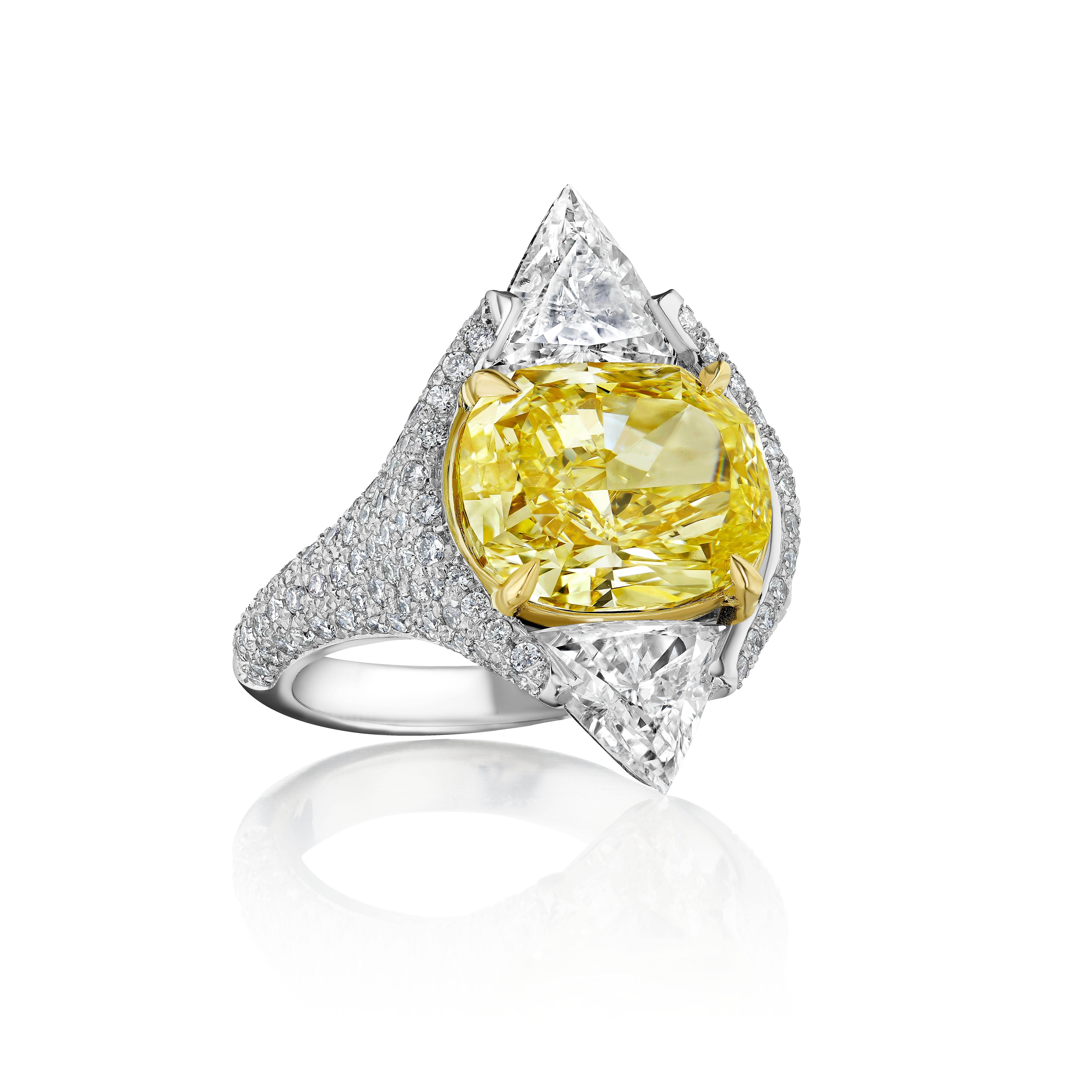 A ultra unique Yellow Diamond Ring. 

Cushion Cut Diamond weighing 6.01 Carats with GIA certificate, graded as Fancy Yellow and VS1 clarity. Triangles weighing 2.01 Carats. Round Diamonds weighing 1.02 Carats. Set in Platinum and 18 Karat Yellow
