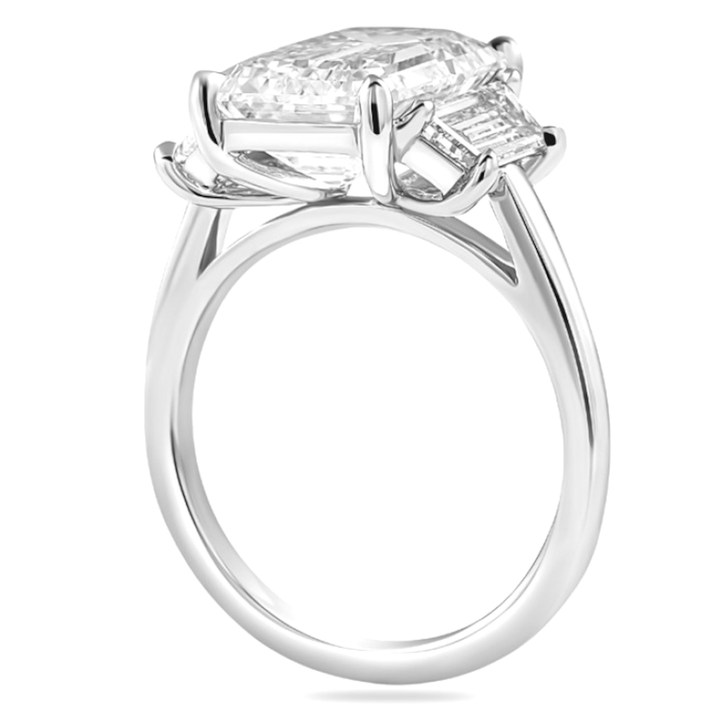 This exceptional GIA certified 6.02 carat emerald cut diamond ring is a striking statement of sophistication and elegance. 
Set in platinum, the centerpiece features a stunning emerald cut diamond known for its clean lines and impressive sparkle.