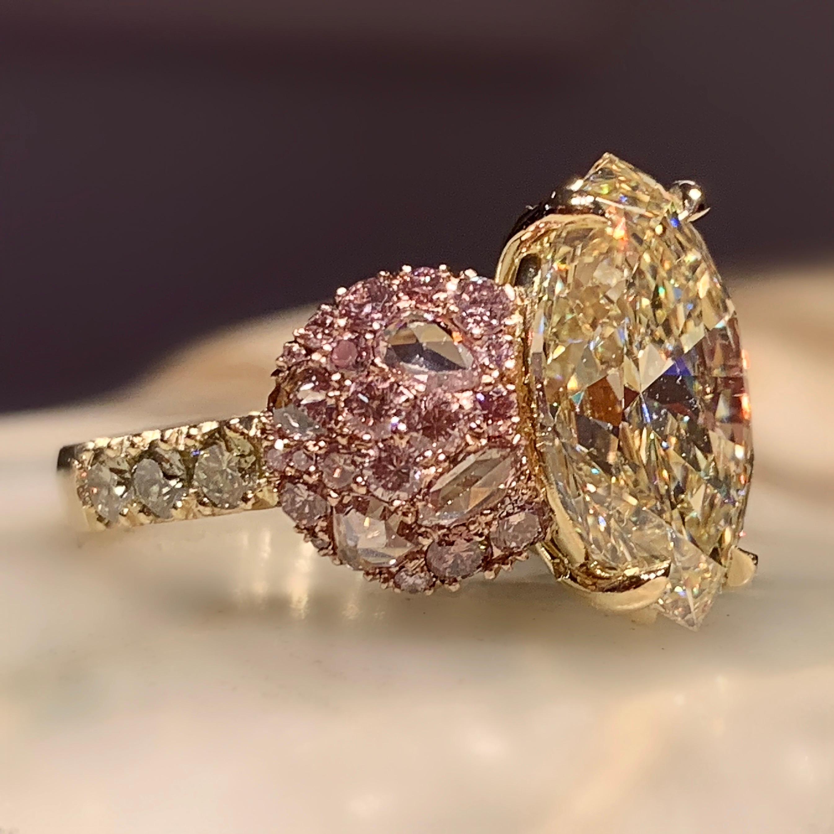 One of a kind ring in 18K Yellow & Rose gold 10,8 g. Set with a GIA Certified Fancy Light Yellow, VS2, 6,02 ct. Marquise shape diamond centerstone, pave set Fancy Pink brilliant-cut diamonds 0,795 ct. Fancy Pink rose-cut diamonds 0,68 ct., Fancy