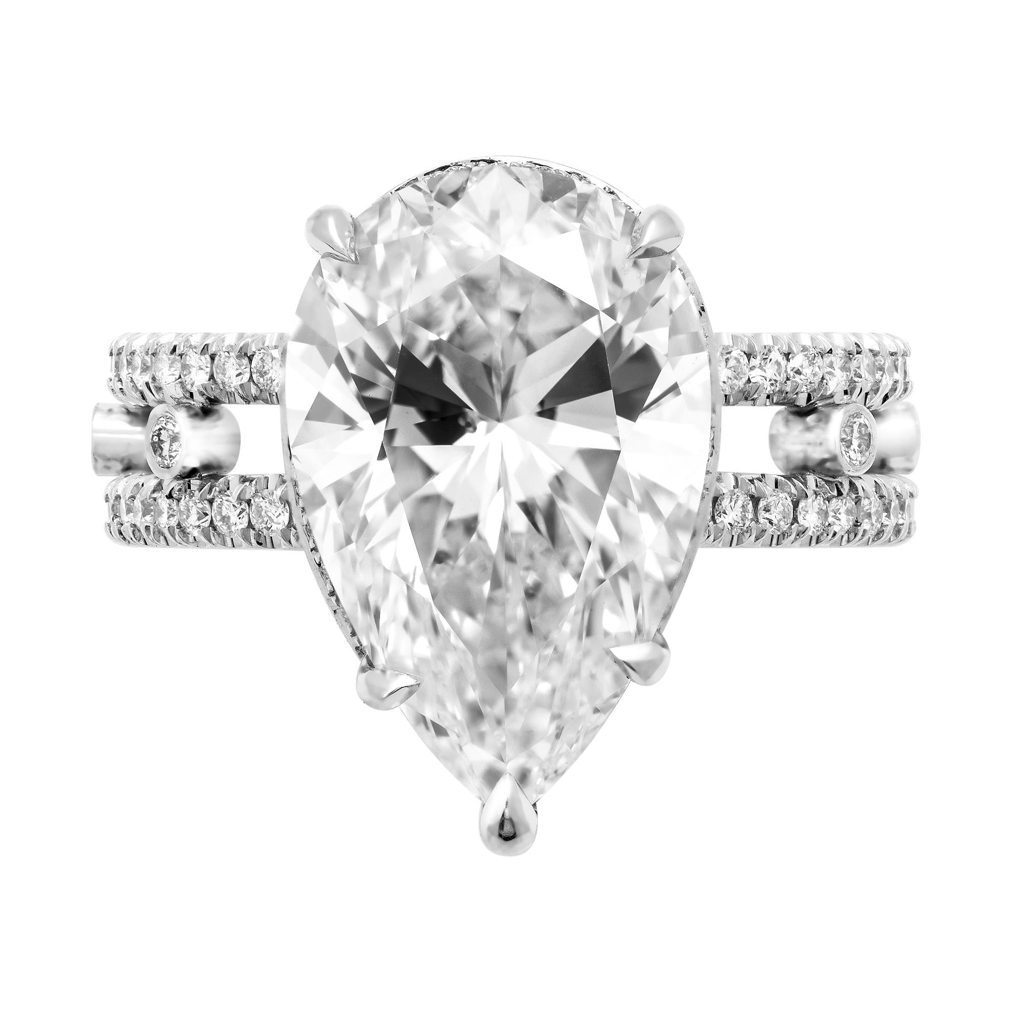 A Magnificent Handmade Engagement Platinum Ring with GIA Certified 6.02CT Pear Shaped Center Diamond in K color SI1 clarity (Faces up White because to Medium Fluorescence and due to the large size, eye Clear).
 The Measurements of the Diamond are