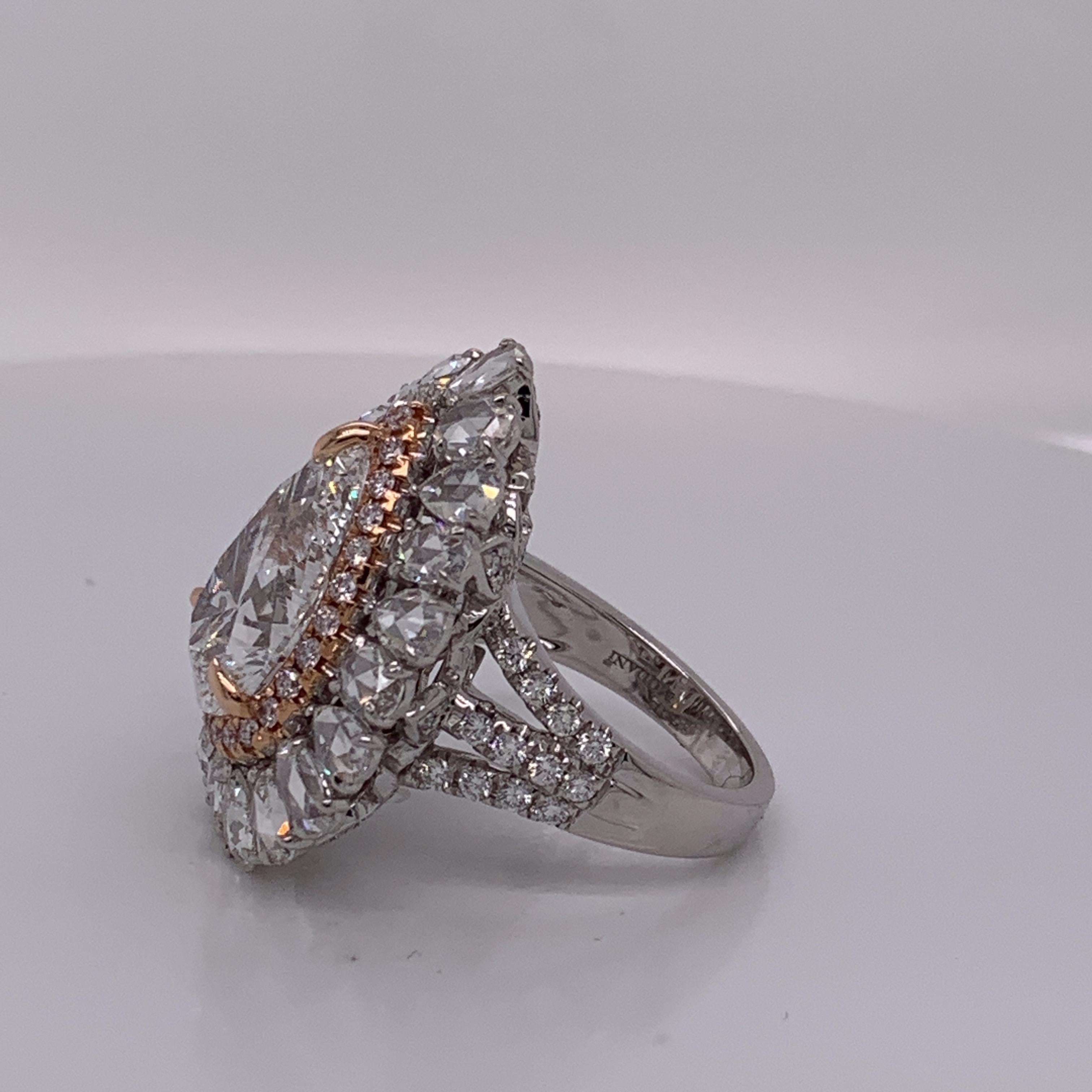 This dazzling white diamond halo ring has a magnificent combination of pink & white diamonds. A pear shape white diamond is set in prongs and framed by pink diamond halo followed by white diamond halo. This exceptional piece is finished with highly