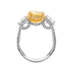GIA Certified 6.02ct Natural Fancy Yellow Even VVS2 Oval Cut Three-Stone Ring