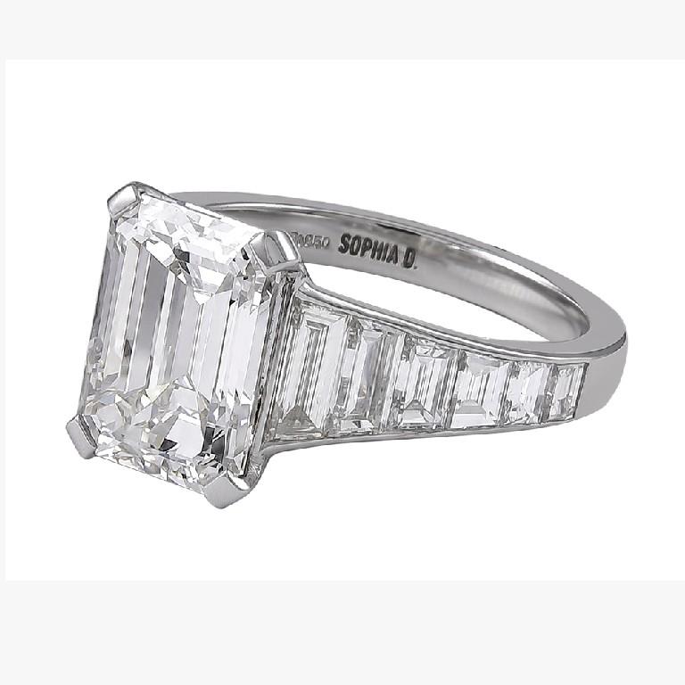 Platinum center emerald cut diamond weighing 6.04 carat with color and clarity being L, VVS2 surrounded with baguette diamonds weighing 0.85 carat and small diamonds 0.27 carat engagement ring. 