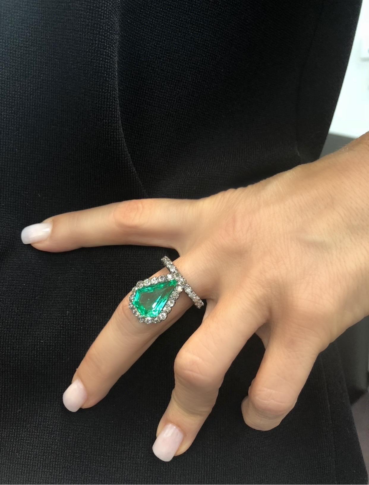 This One-Of-A-Kind Colombian Emerald Shield ring is truly magnificent. ( please see all photos)
The Gia Certified shield emerald is 6.06 CTW. Set in 18k gold with a rhodium finish. (GIA report attached ) Diamonds around emerald are set in silver