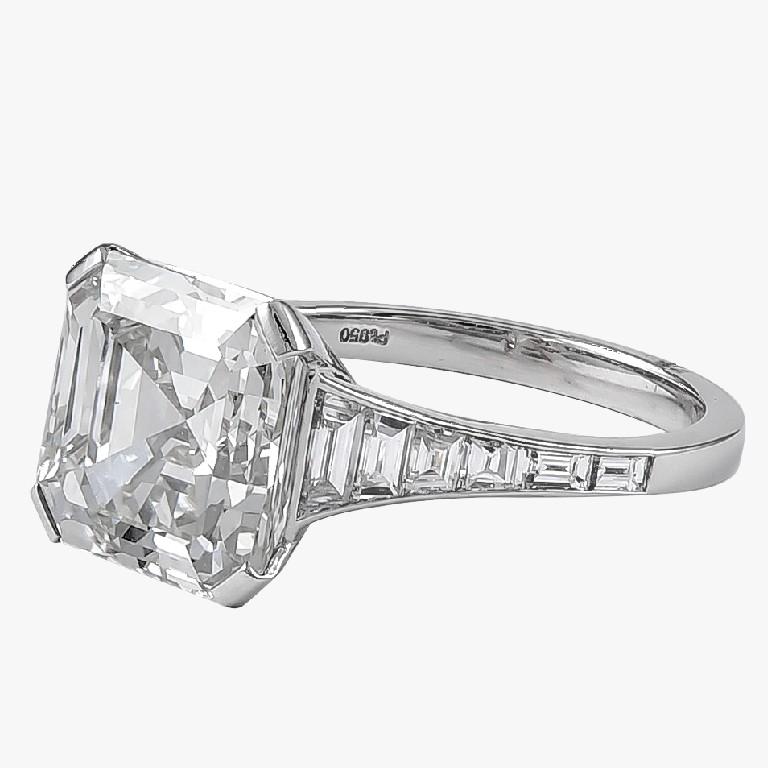GIA certified 6.06 carat emerald cut center diamond surrounded with gorgeous small diamonds with the total weight of 0.72 carat engagement ring. 