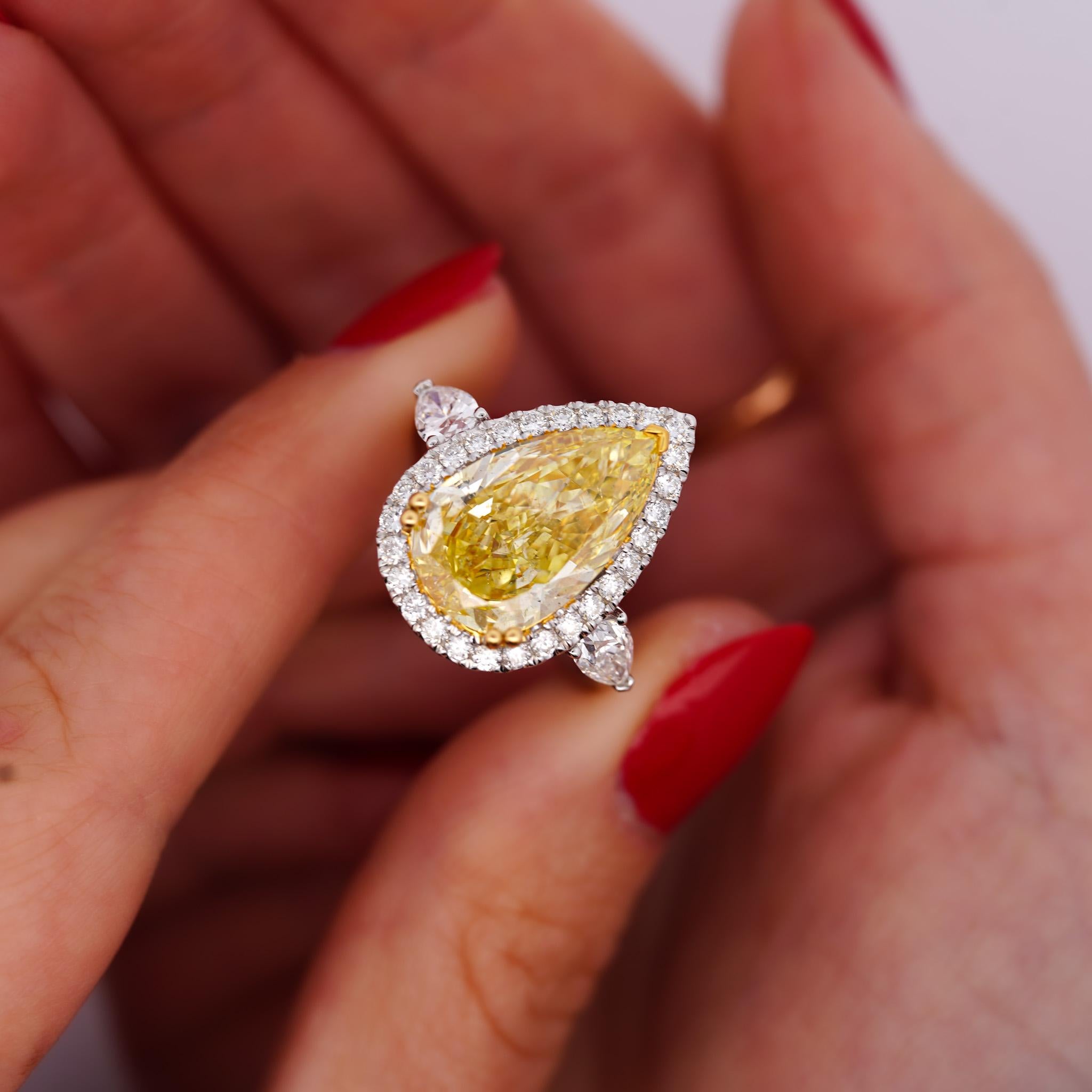 GIA Certified 6.06 Carat Fancy Intense Yellow Pear Cut Diamond Engagement Ring in 18K Gold Halo Filigree Shank and Pear Cut Diamond Side Stones. 

Details:
Item Type: Engagement Ring
Metal: 18K Yellow & White Gold
Size: 7 (adjustable)
Shank: Halo,