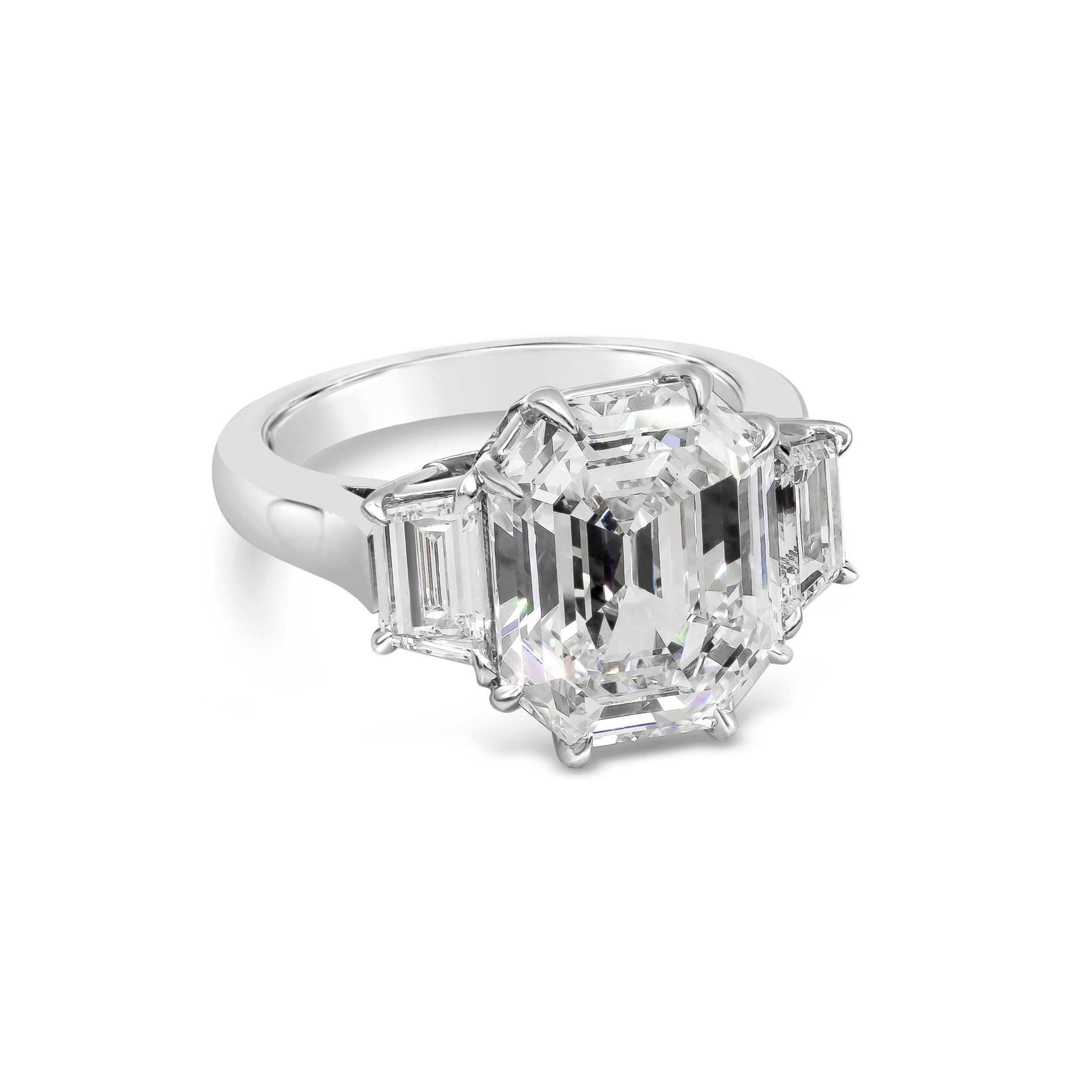 An elegant and unique GIA certified octagon shaped step cut diamond weighing 6.08 carats, set in an eight prong polished platinum basket and flanked by two trapezoid diamonds. Center stone is I color and VS2 clarity. Size 6 US, resizable upon
